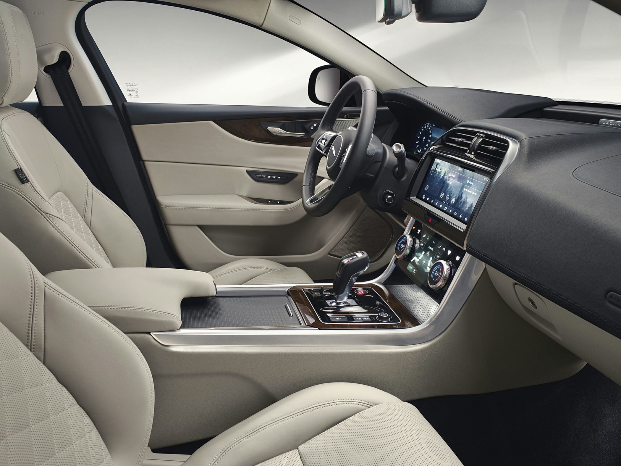 Beige leather seats, dual touchscreen infotainment, modern steering wheel, and digital dashboard.