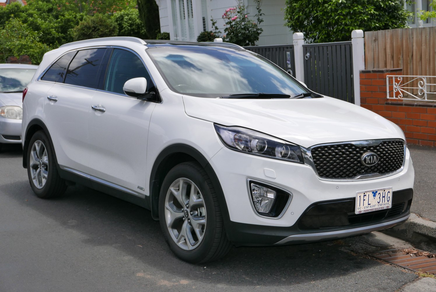 White SUV front side view with distinctive grille and headlamps