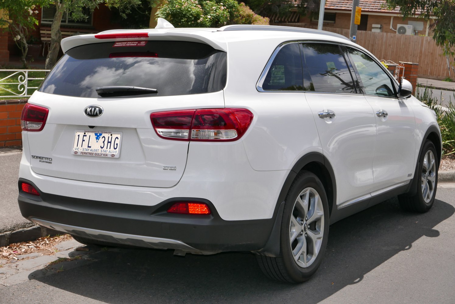 Rear and side view of white SUV with distinctive taillights and alloy wheels