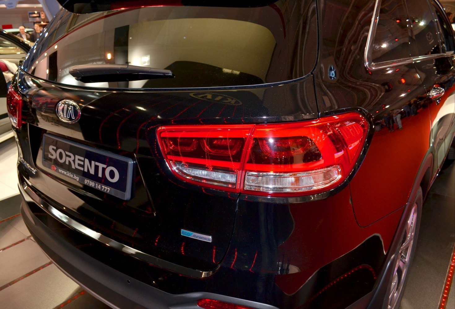 Rear view with distinct tail light and rear window wiper on black SUV