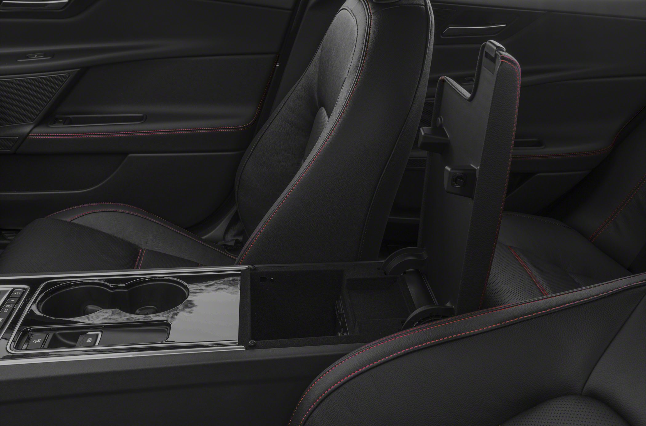Black leather seats with red stitching and open center console storage