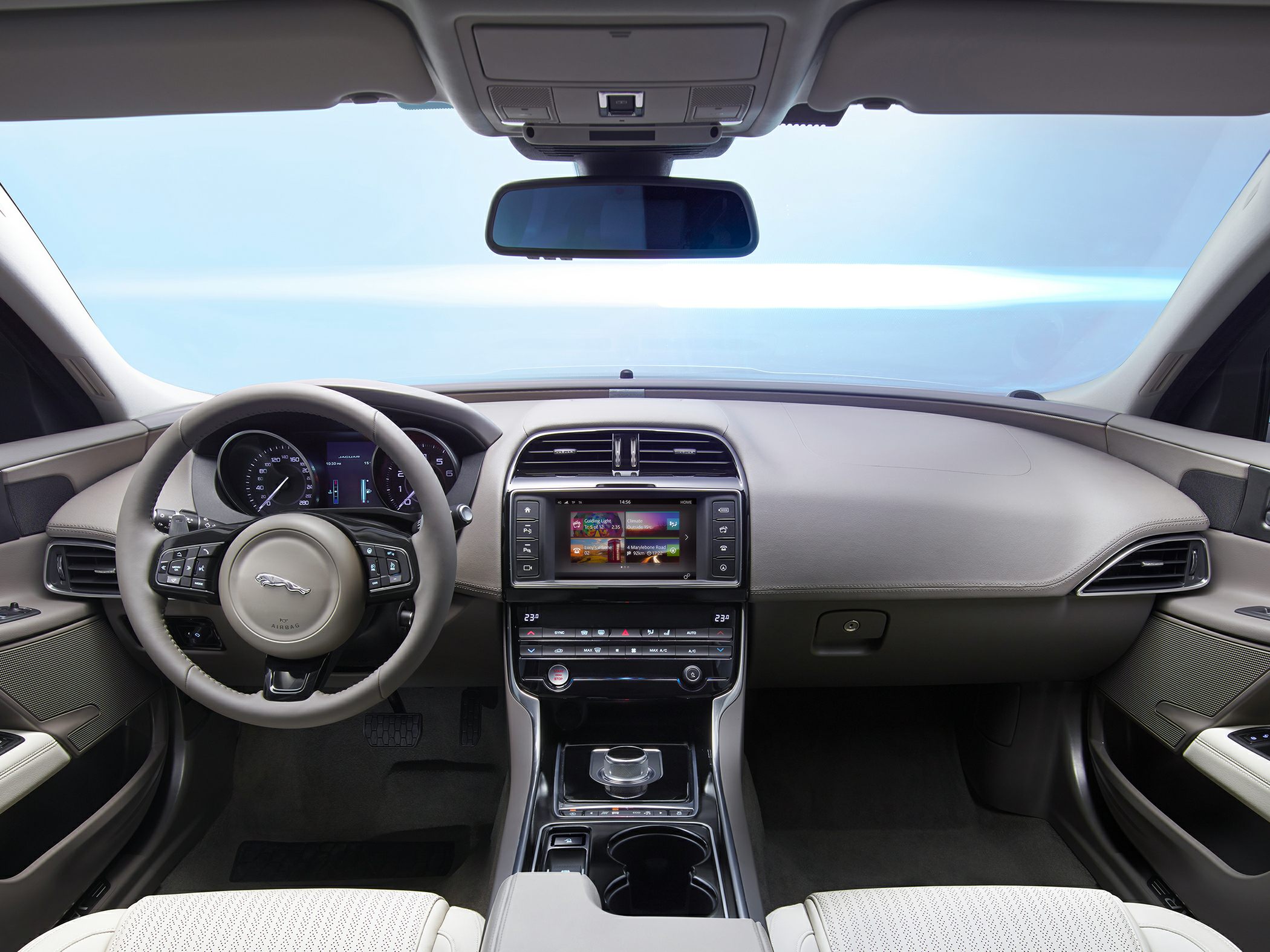 Luxurious car interior with dashboard, steering wheel, and infotainment system