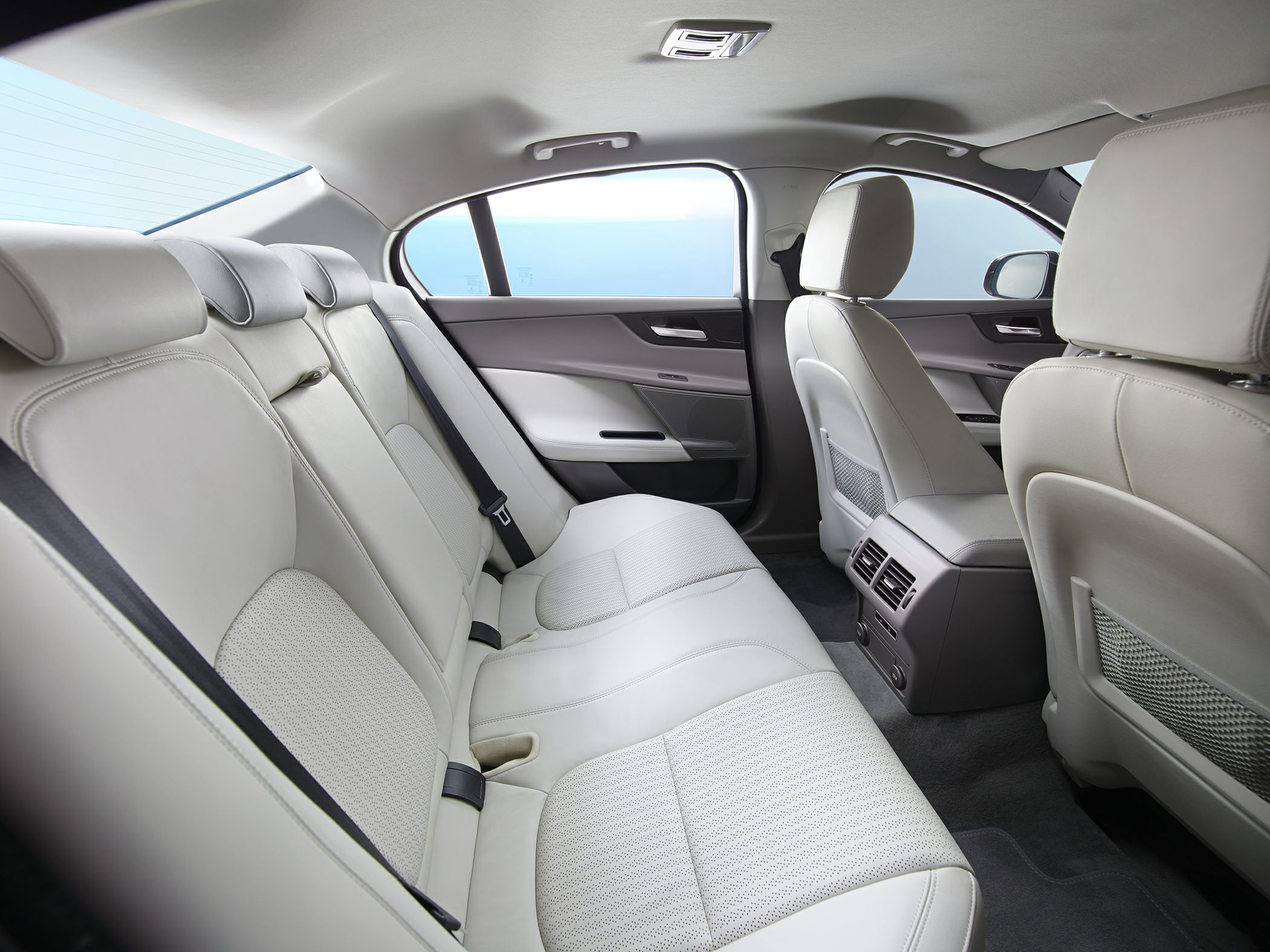 Rear leather seats and spacious luxury interior in light beige.