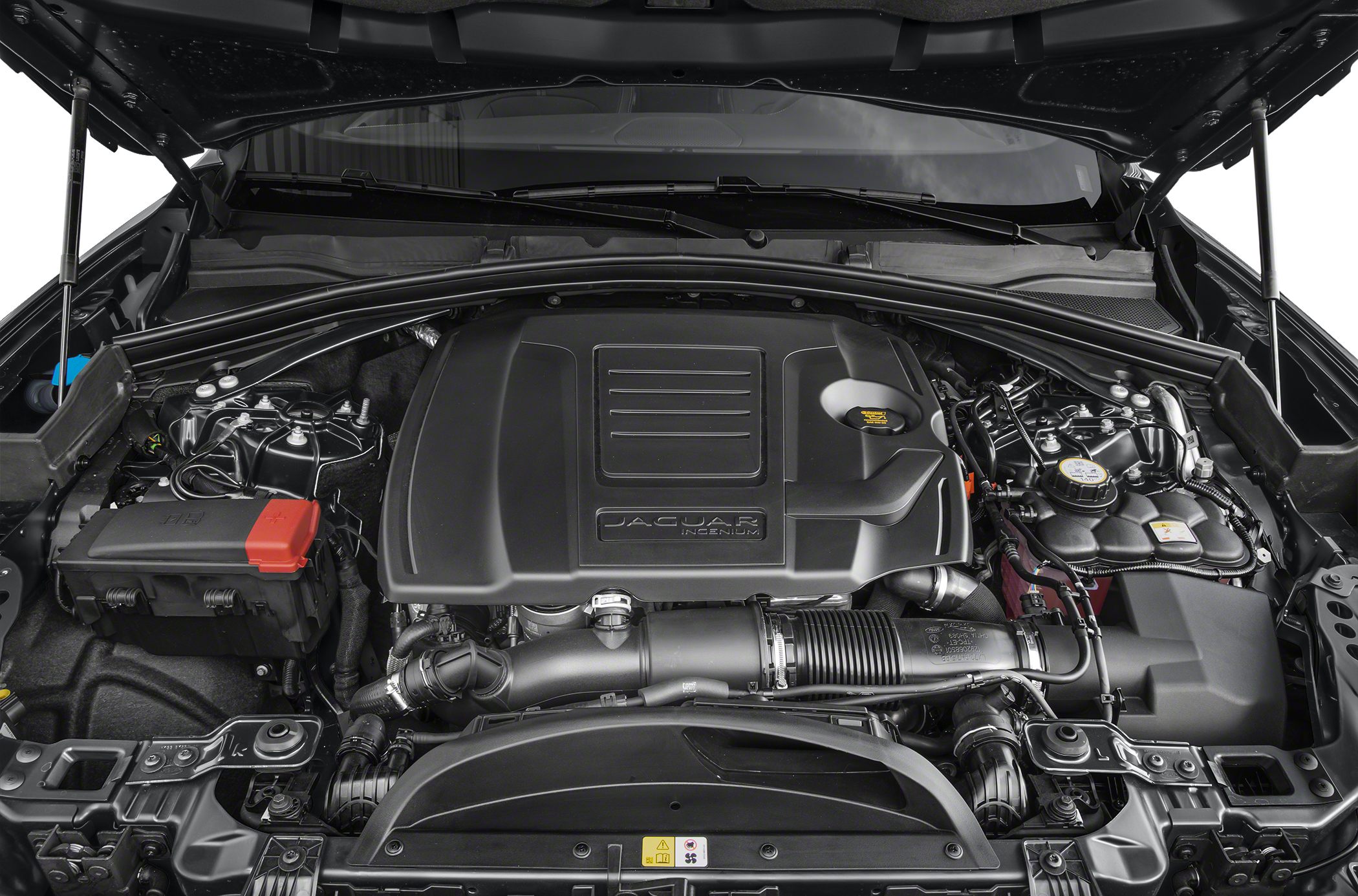 Engine bay with detailed engine cover and components under open hood