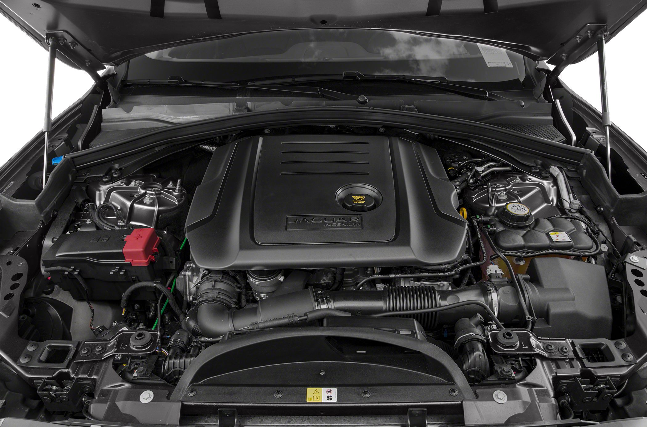 Engine bay with a large engine cover and visible mechanical components