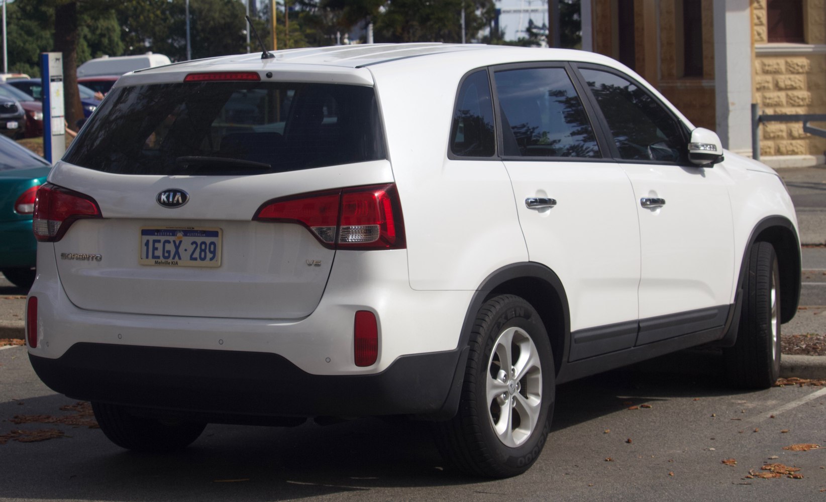 Rear view of a white SUV with distinct tail lights and V6 badge