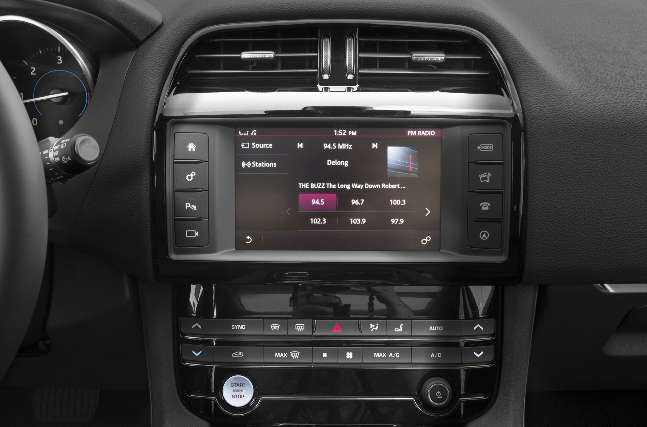 Infotainment screen and dashboard climate controls with start-stop button
