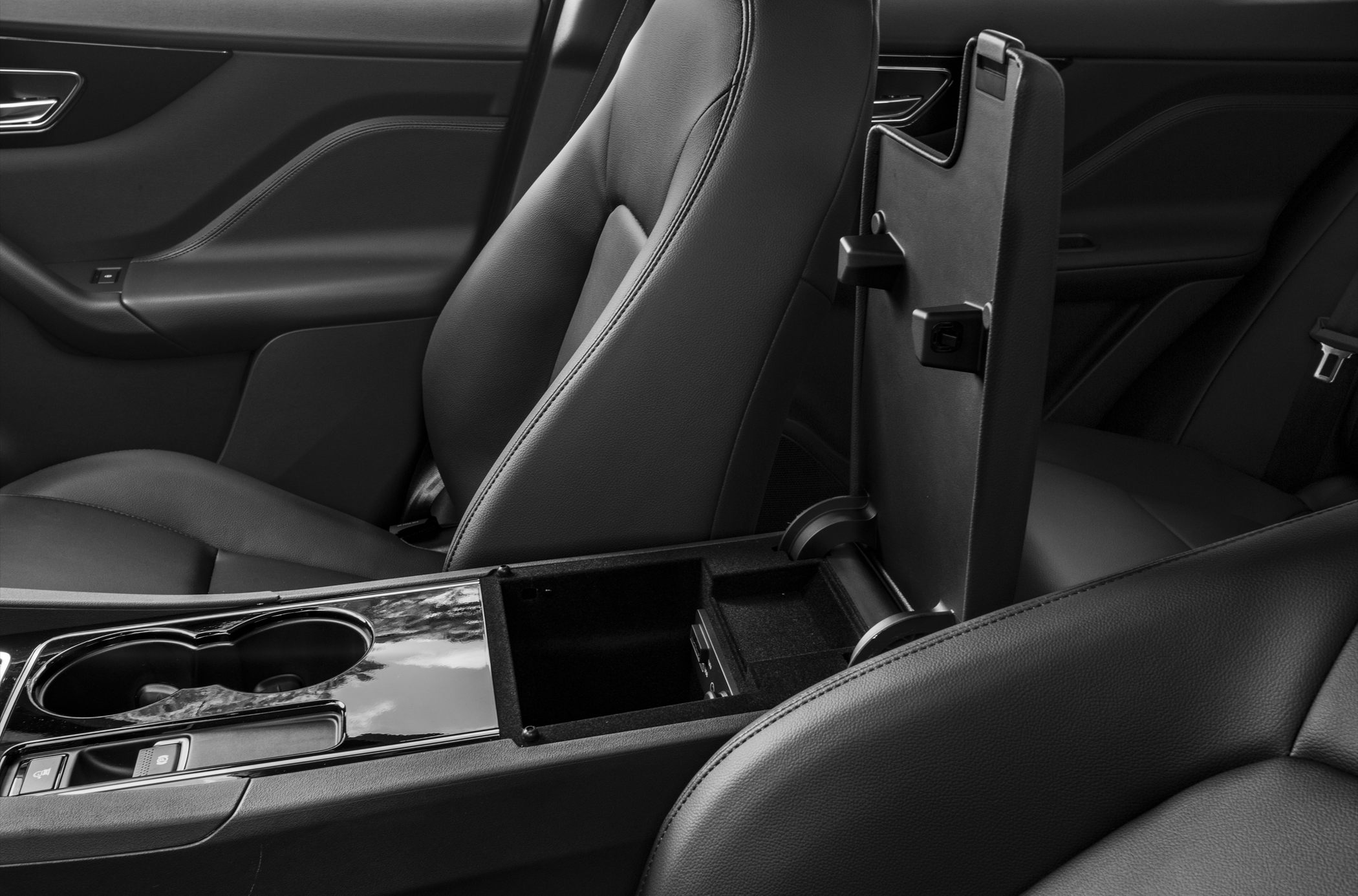 Black leather seats with open center console and storage compartment