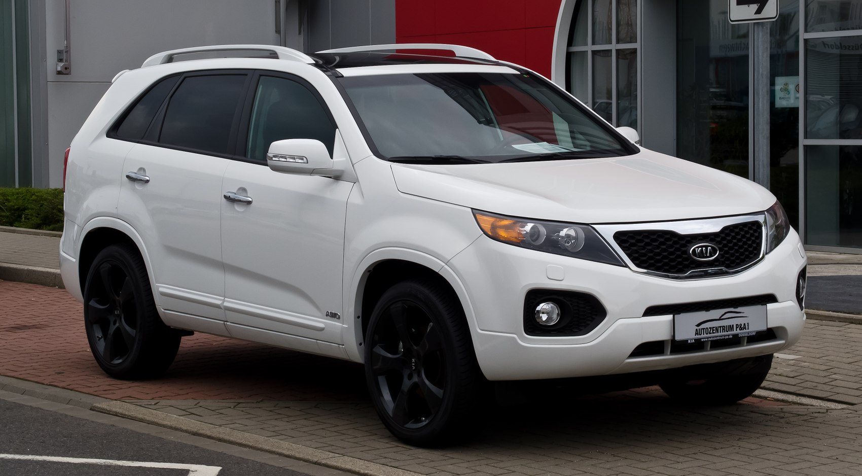 White SUV with distinctive headlights and black alloy wheels.
