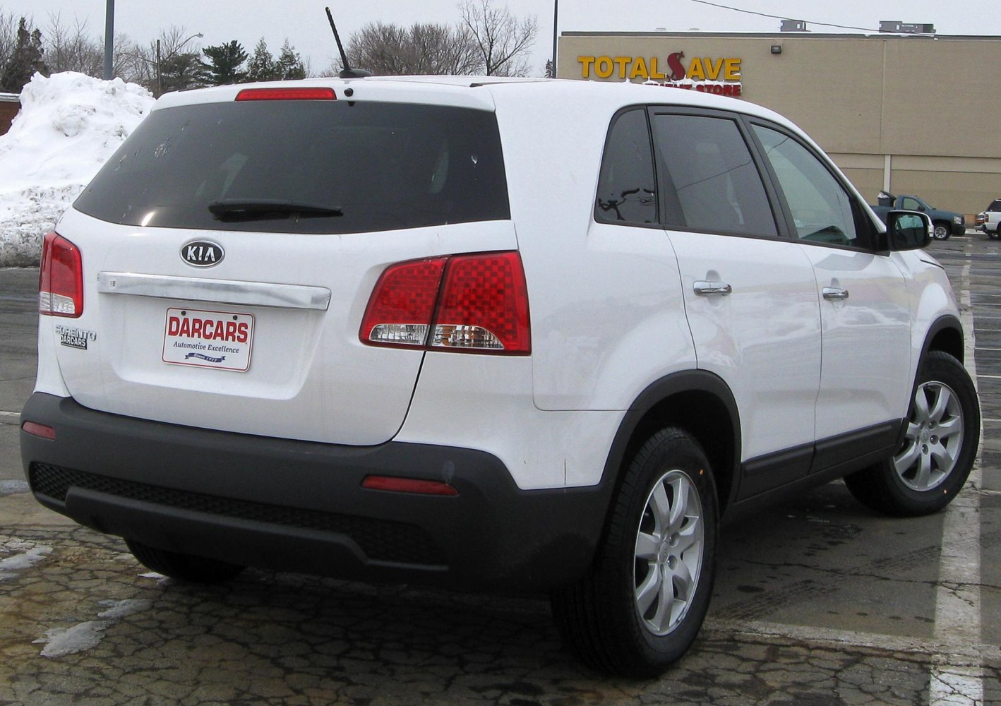 Rear view of white SUV with distinctive red tail lights and tinted rear windows
