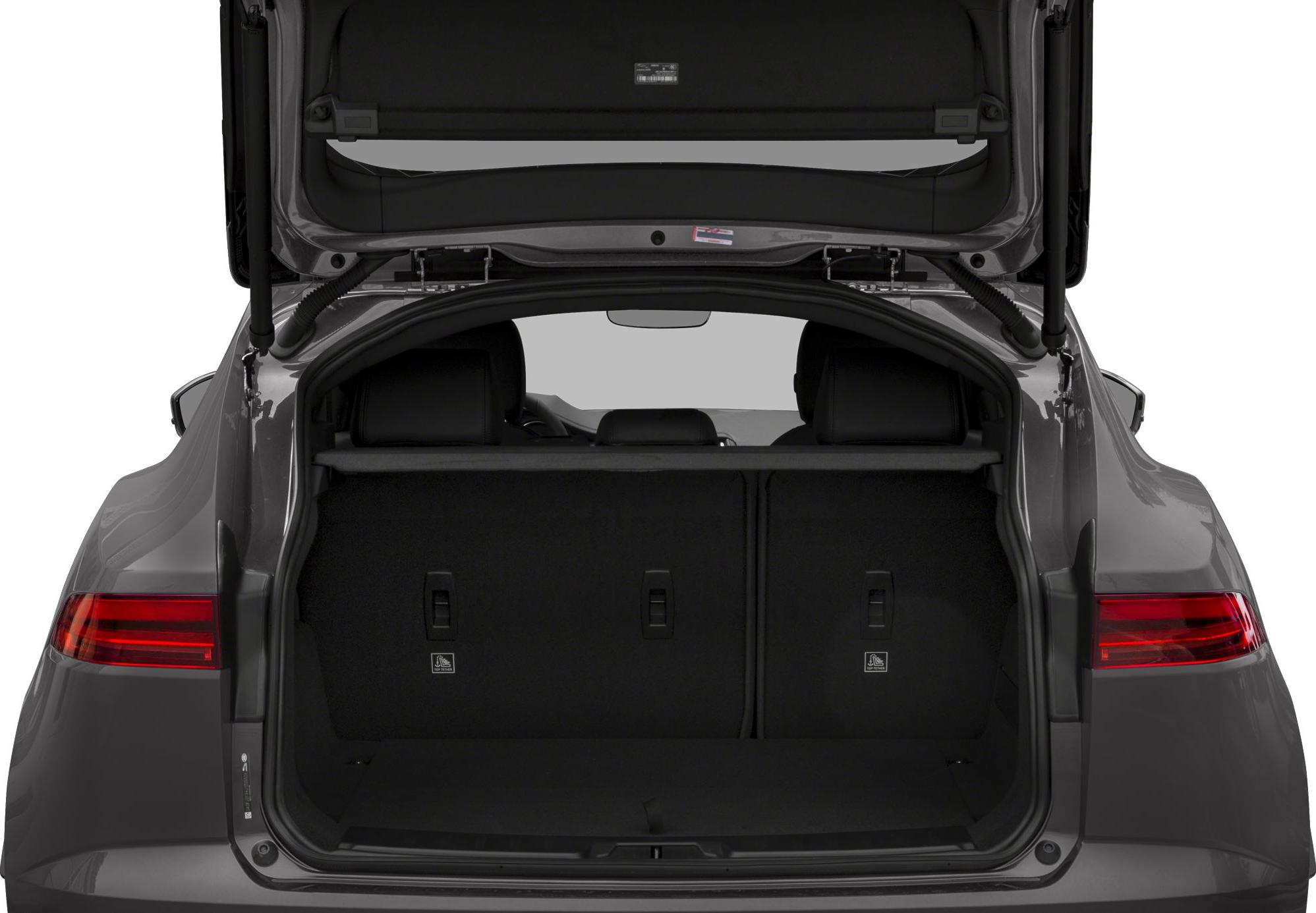Open rear trunk showing interior cargo space with seats visible.