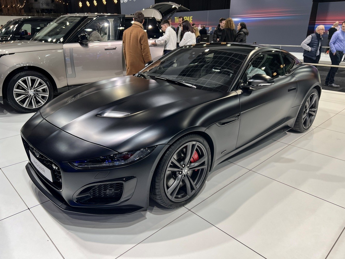 Matte black coupe with alloy wheels and aerodynamic design