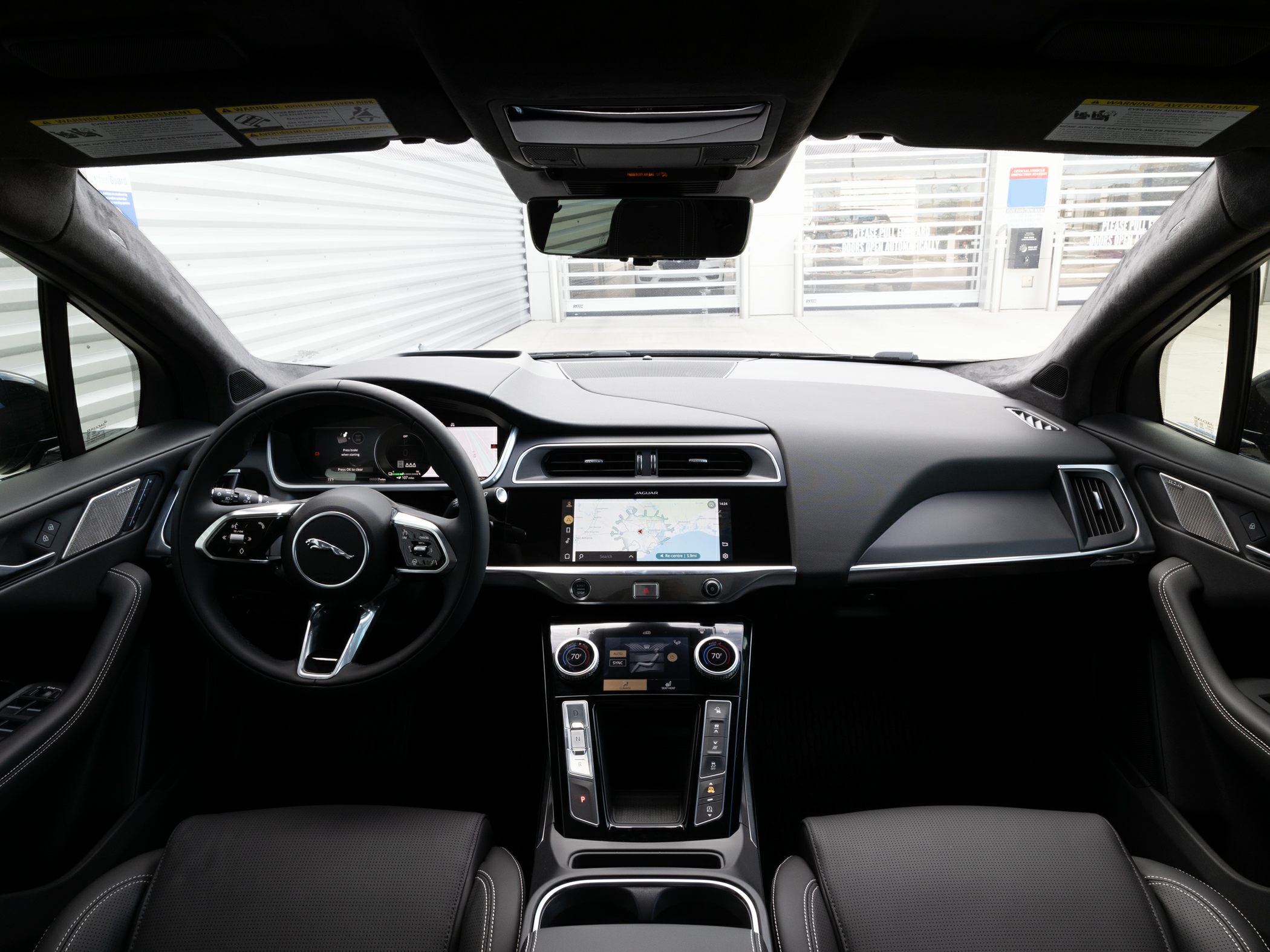 Dashboard with touchscreen and steering wheel with controls in modern interior
