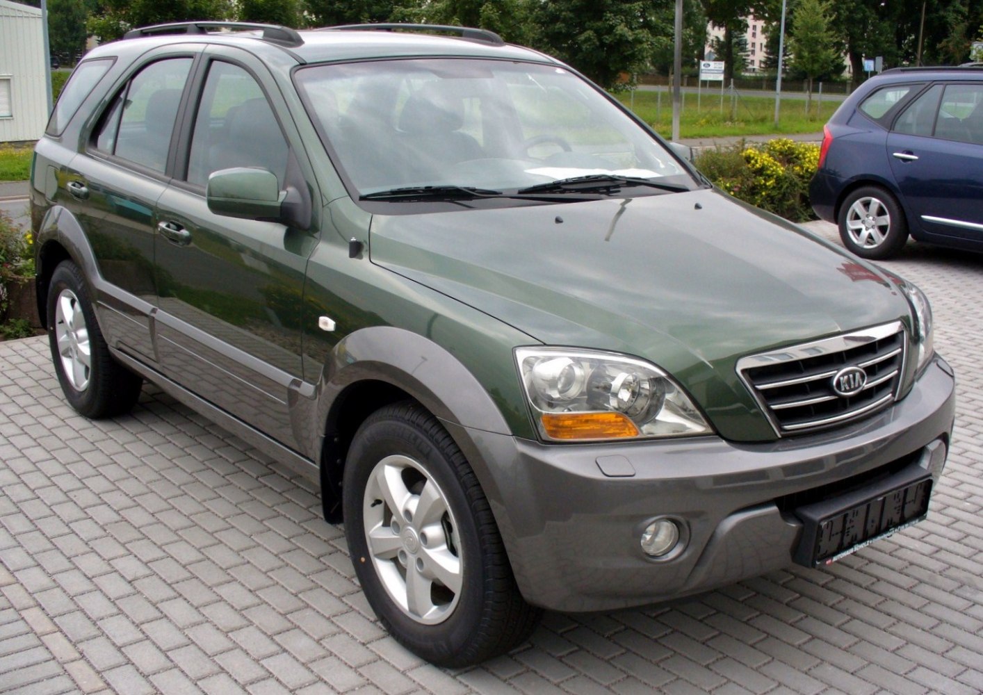 Front side view of an SUV with prominent headlights and grille