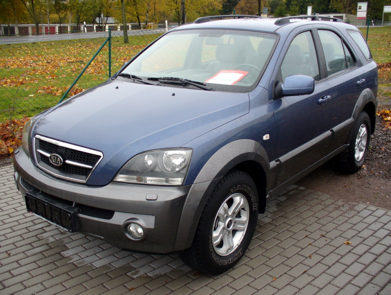 Front side view of SUV with alloy wheels and rugged trim