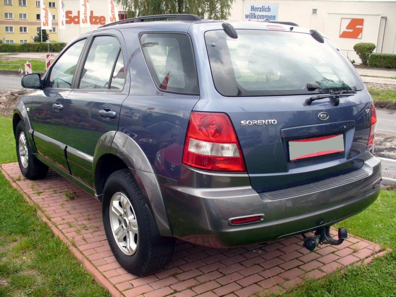 Rear and side view of SUV with rear wiper and tow hitch