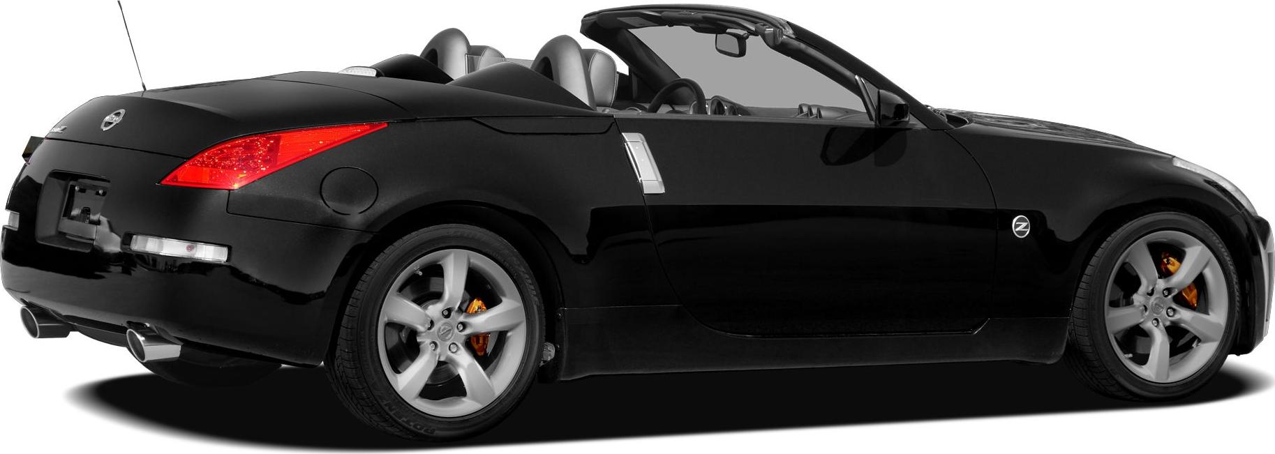 Side view of sleek black convertible with dual exhaust and alloy wheels