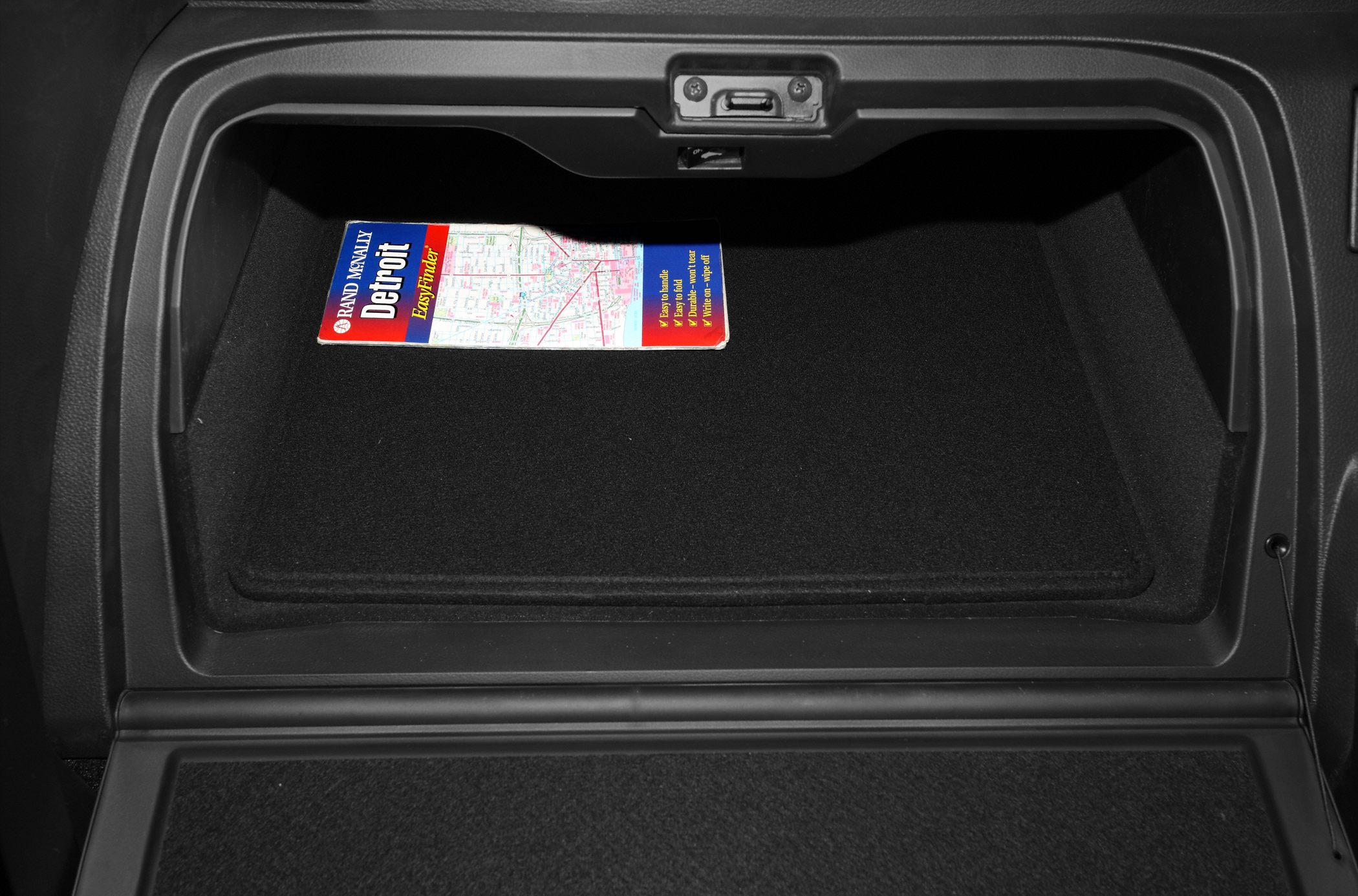 Car glove compartment with a map inside