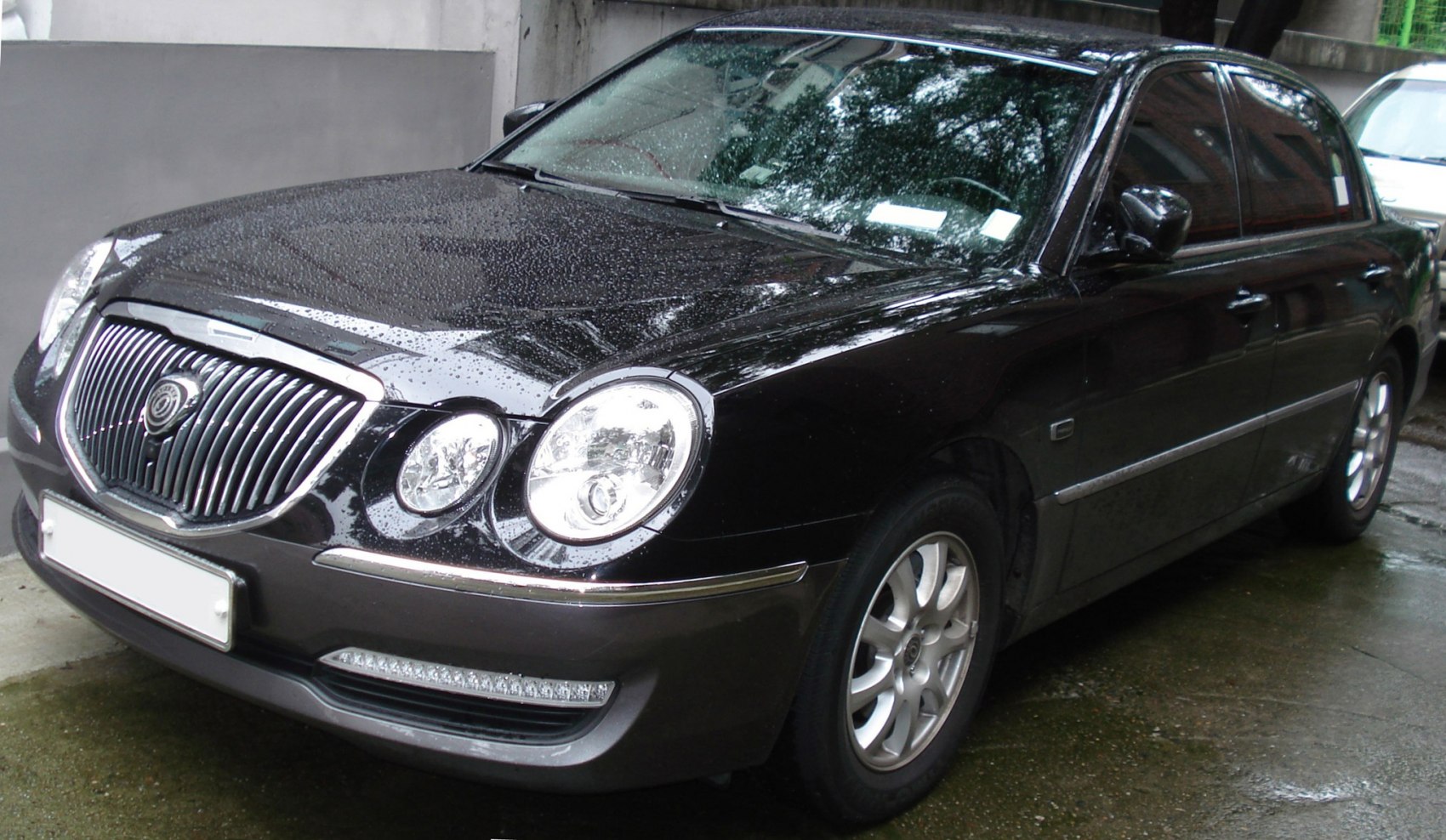Luxury sedan with chrome grille and dual round headlights