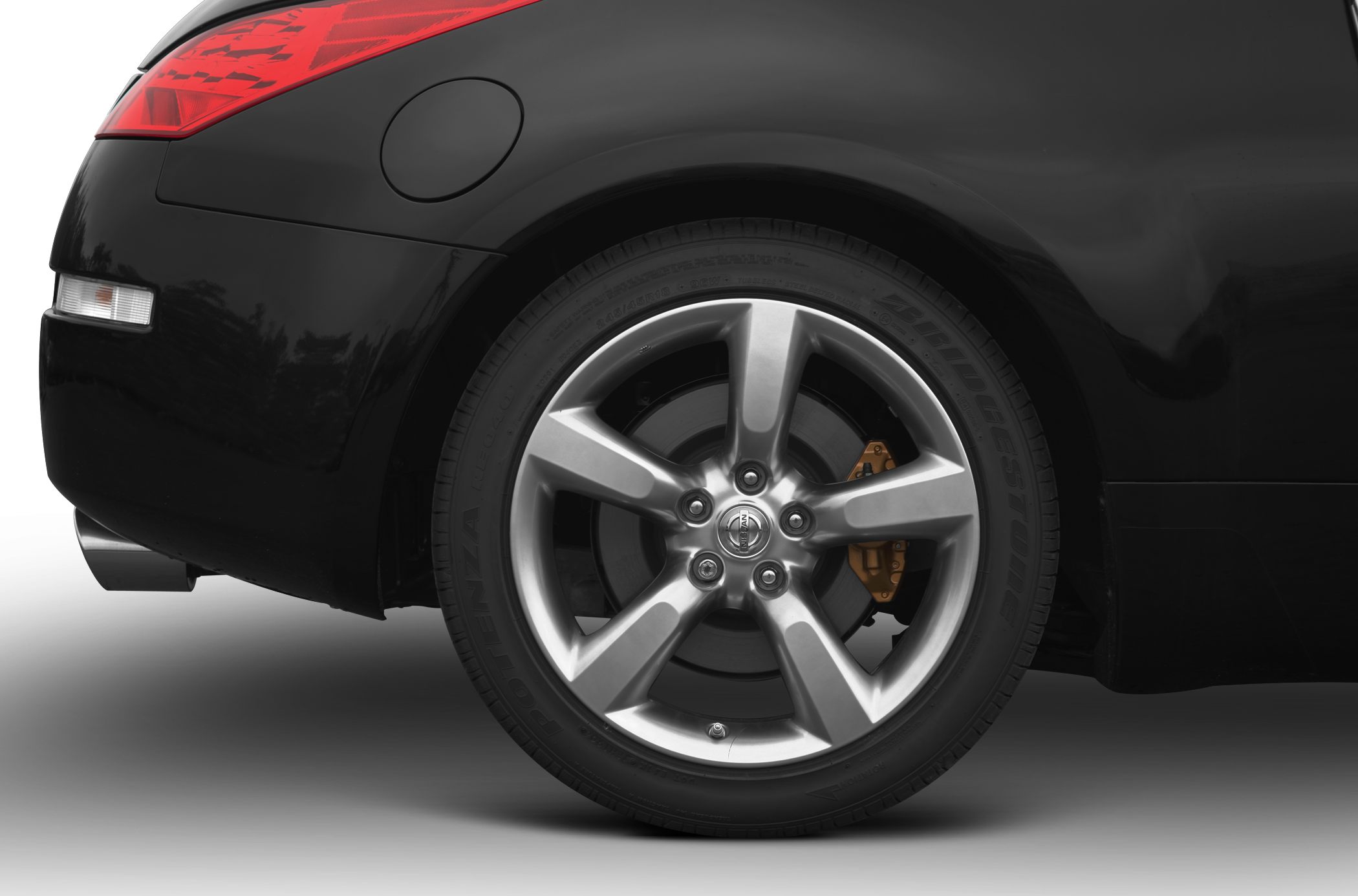 Rear wheel with alloy rim and brake caliper on a sports car