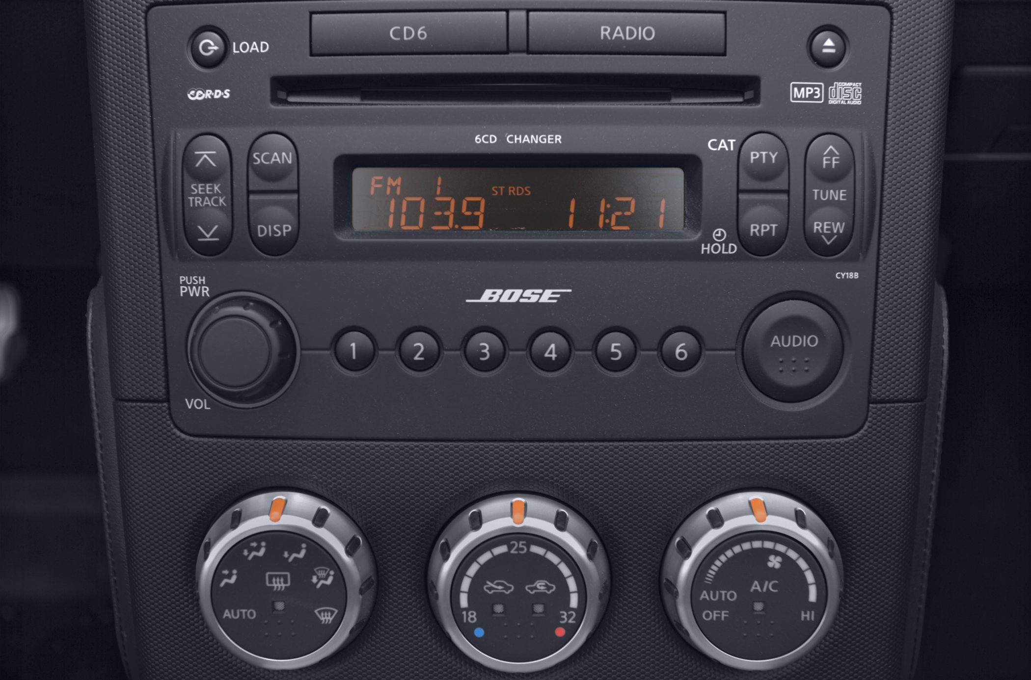 Car radio with Bose audio and climate control dials.