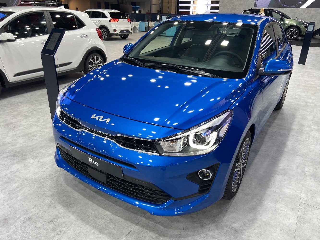 Front LED headlights and grille of a compact hatchback.