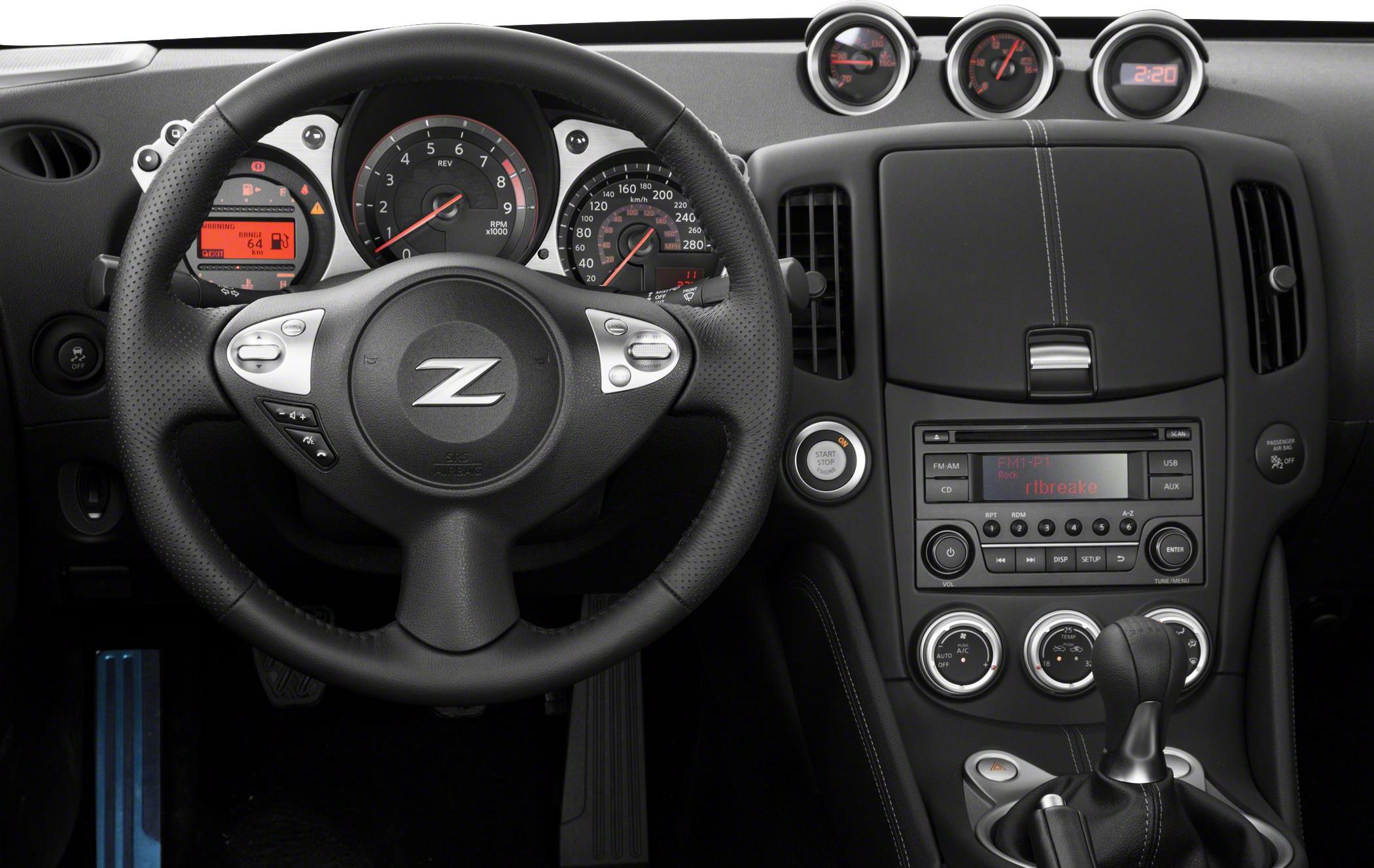 Sporty steering wheel, dashboard instruments, and center console controls