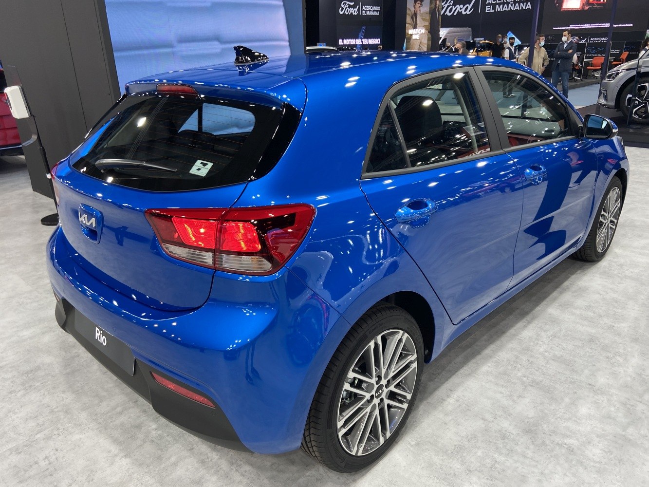 Rear side view of a blue hatchback with modern taillights and alloy wheels