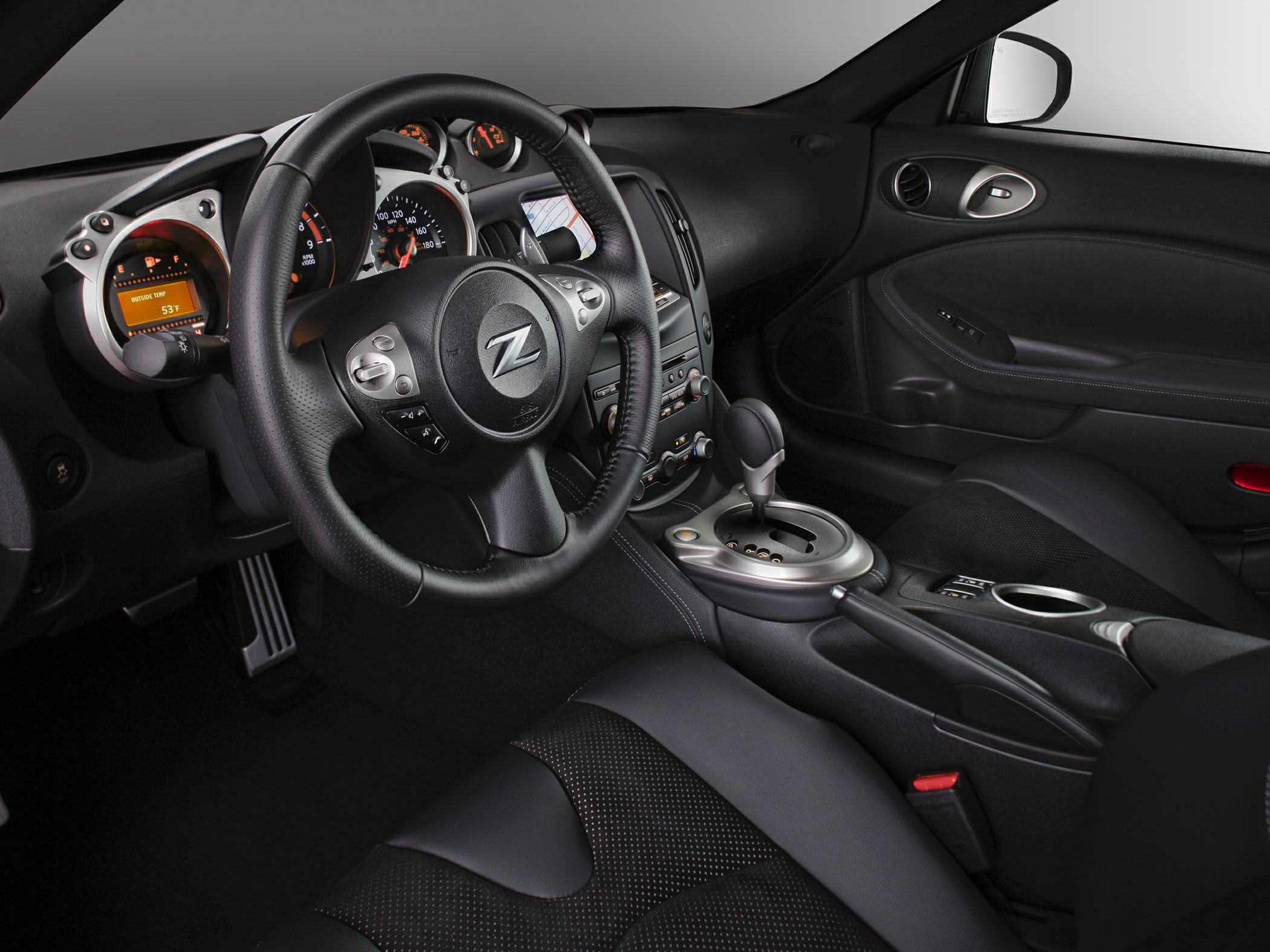 Dashboard with instrument panel and steering wheel with controls.