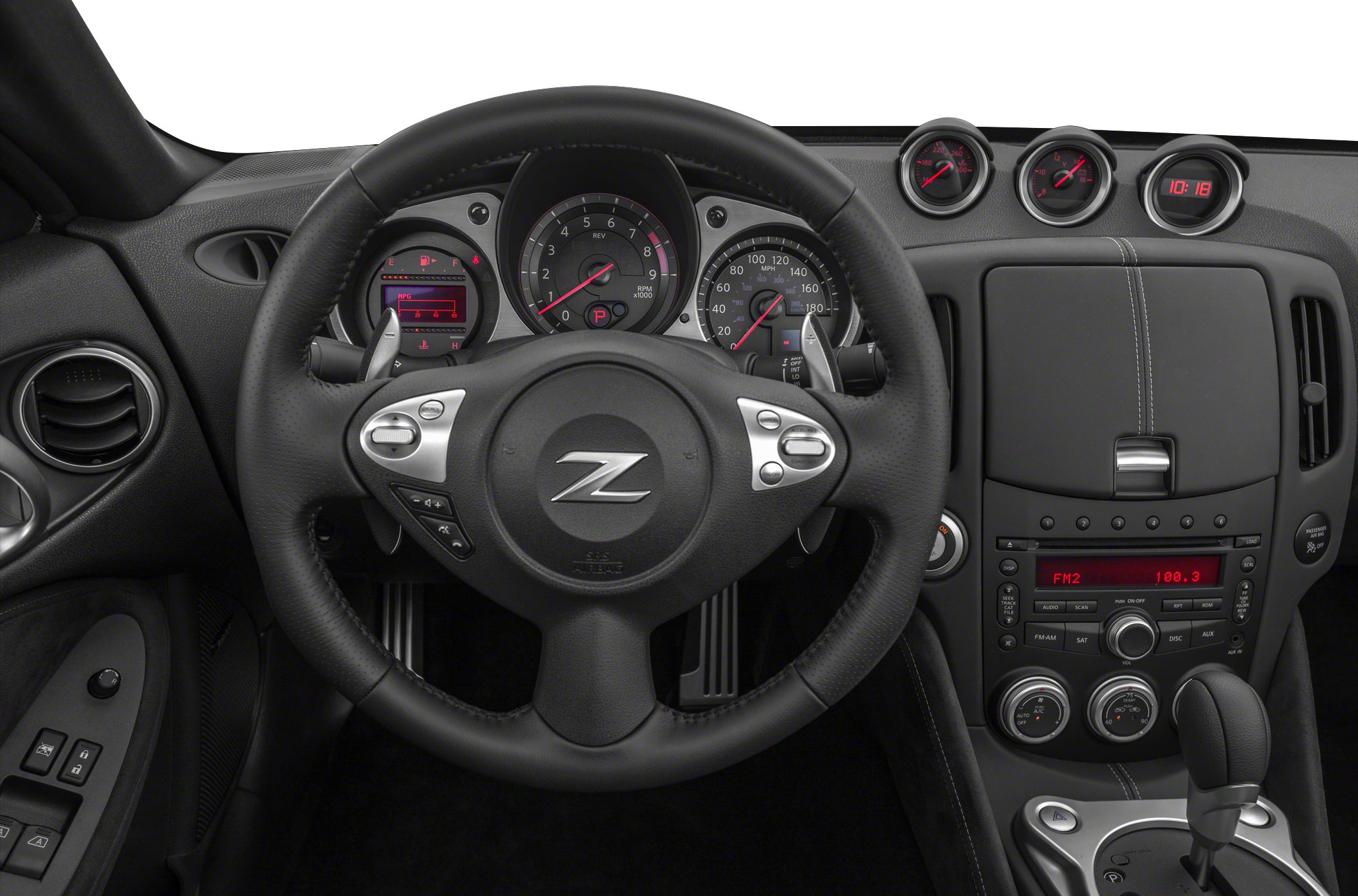 Steering wheel and detailed dashboard with gauges and controls.