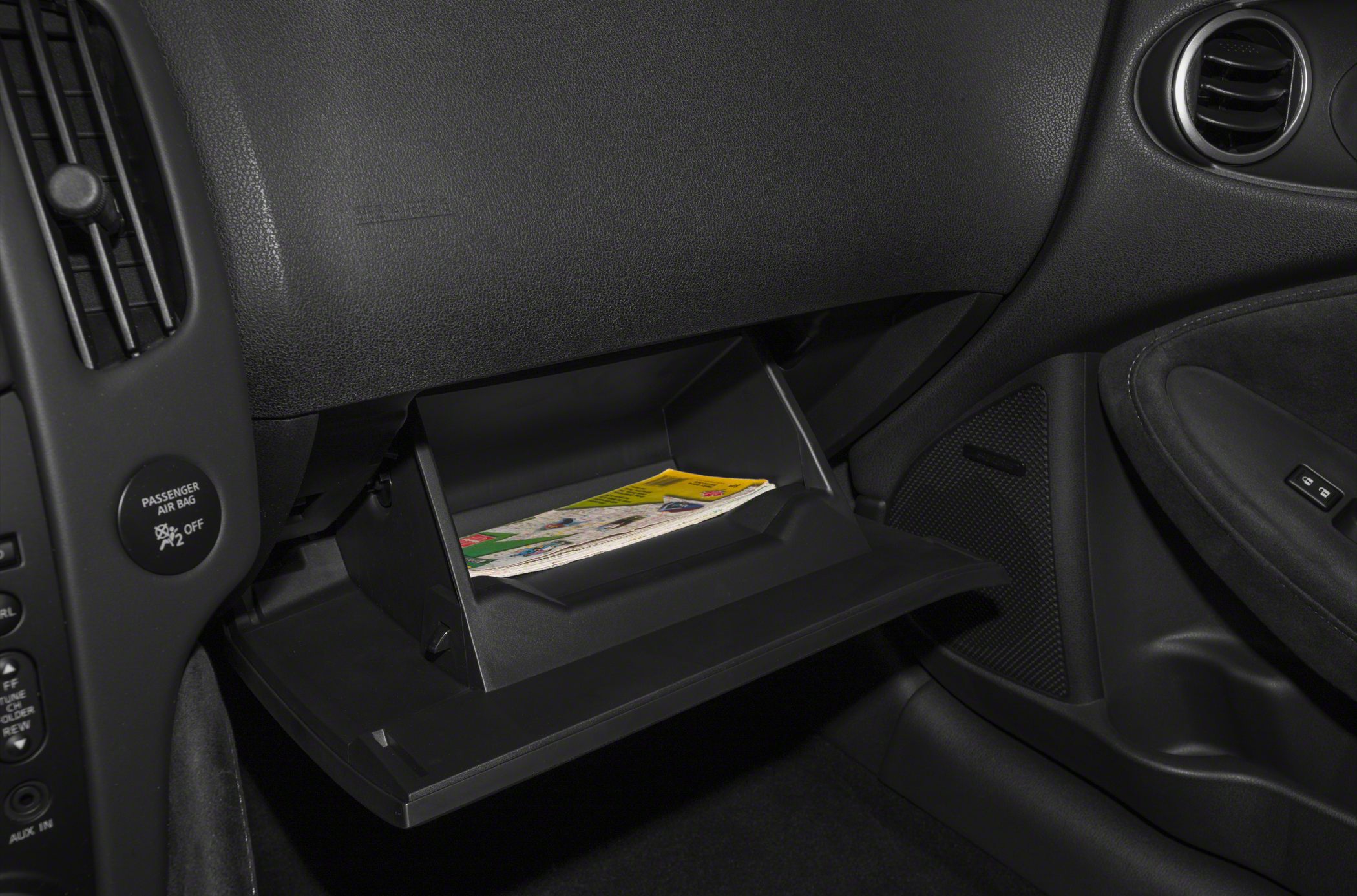 Open glove compartment with passenger airbag in car interior