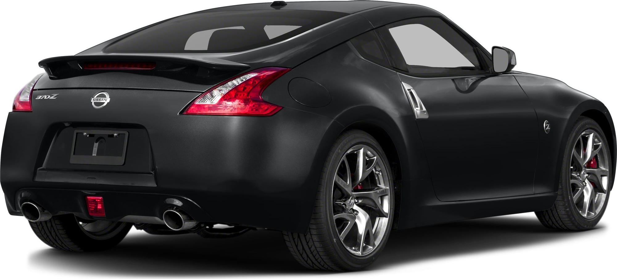 Rear angle view showing dual exhausts, alloy wheels, and sleek coupe silhouette.