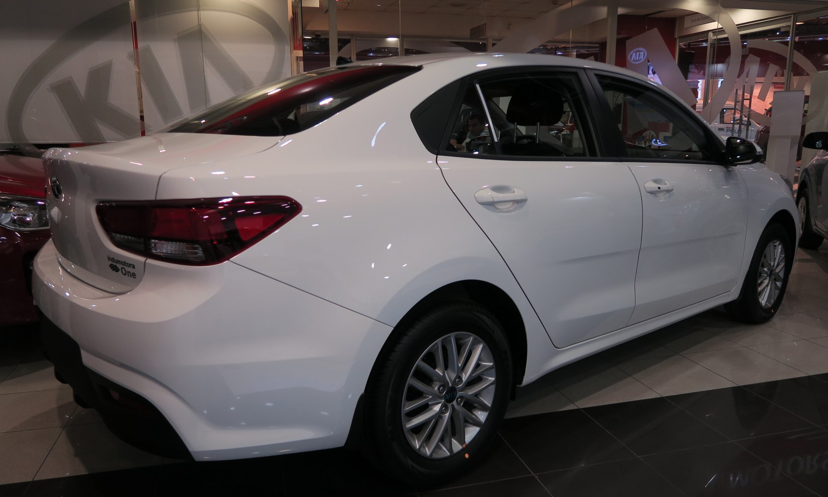 Rear side view of a streamlined white sedan with alloy wheels