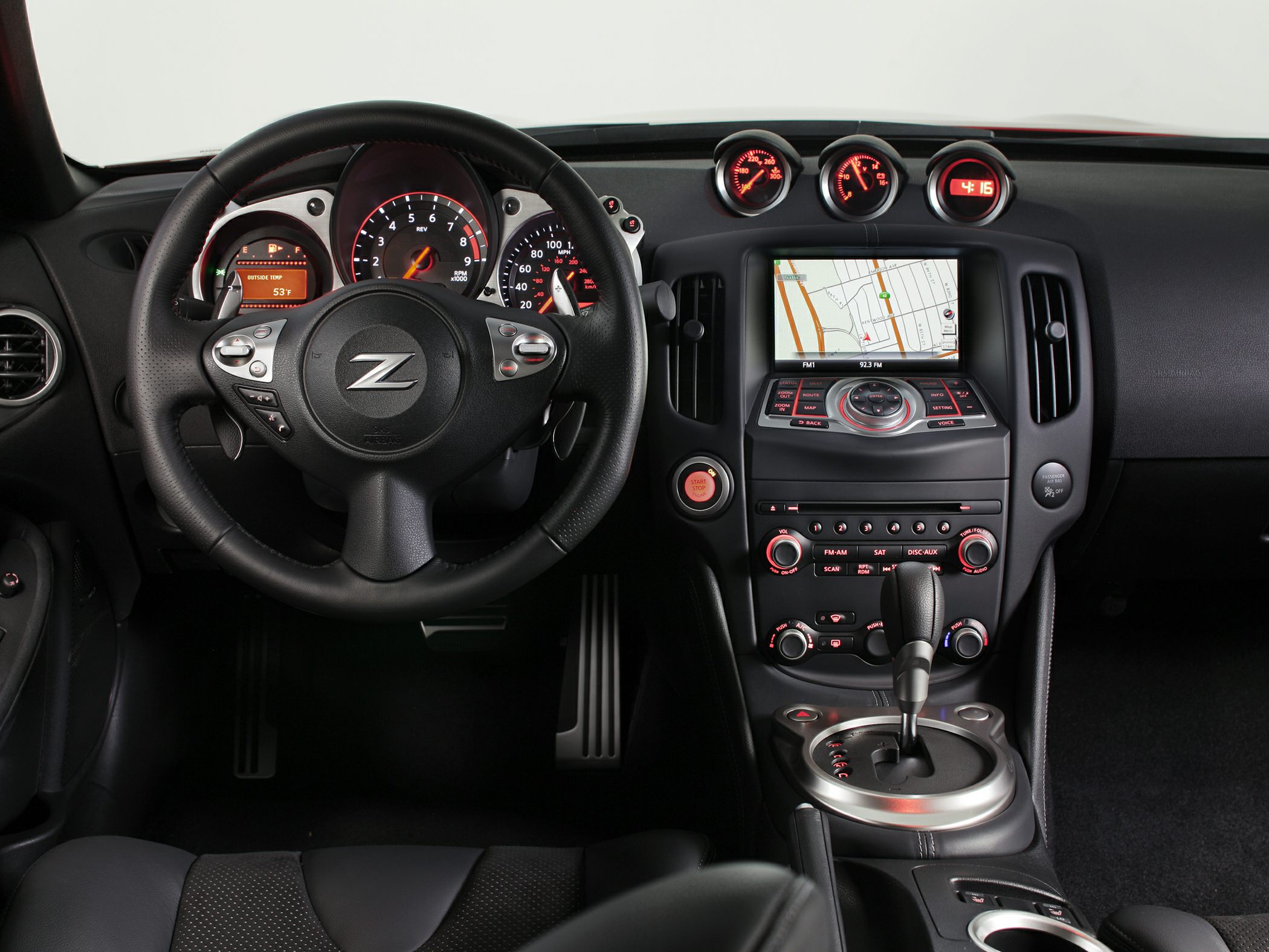 Sporty steering wheel and central infotainment system with gauges.