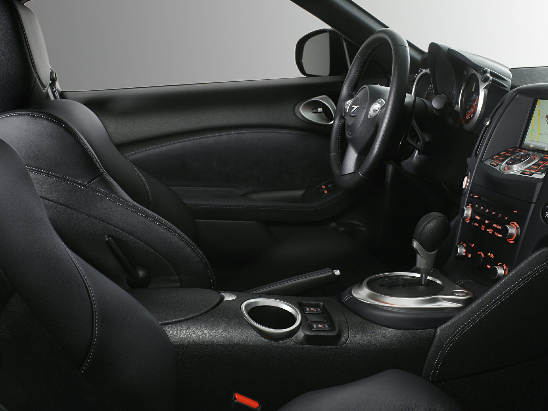Sporty car interior with dashboard, steering wheel, automatic gear shift