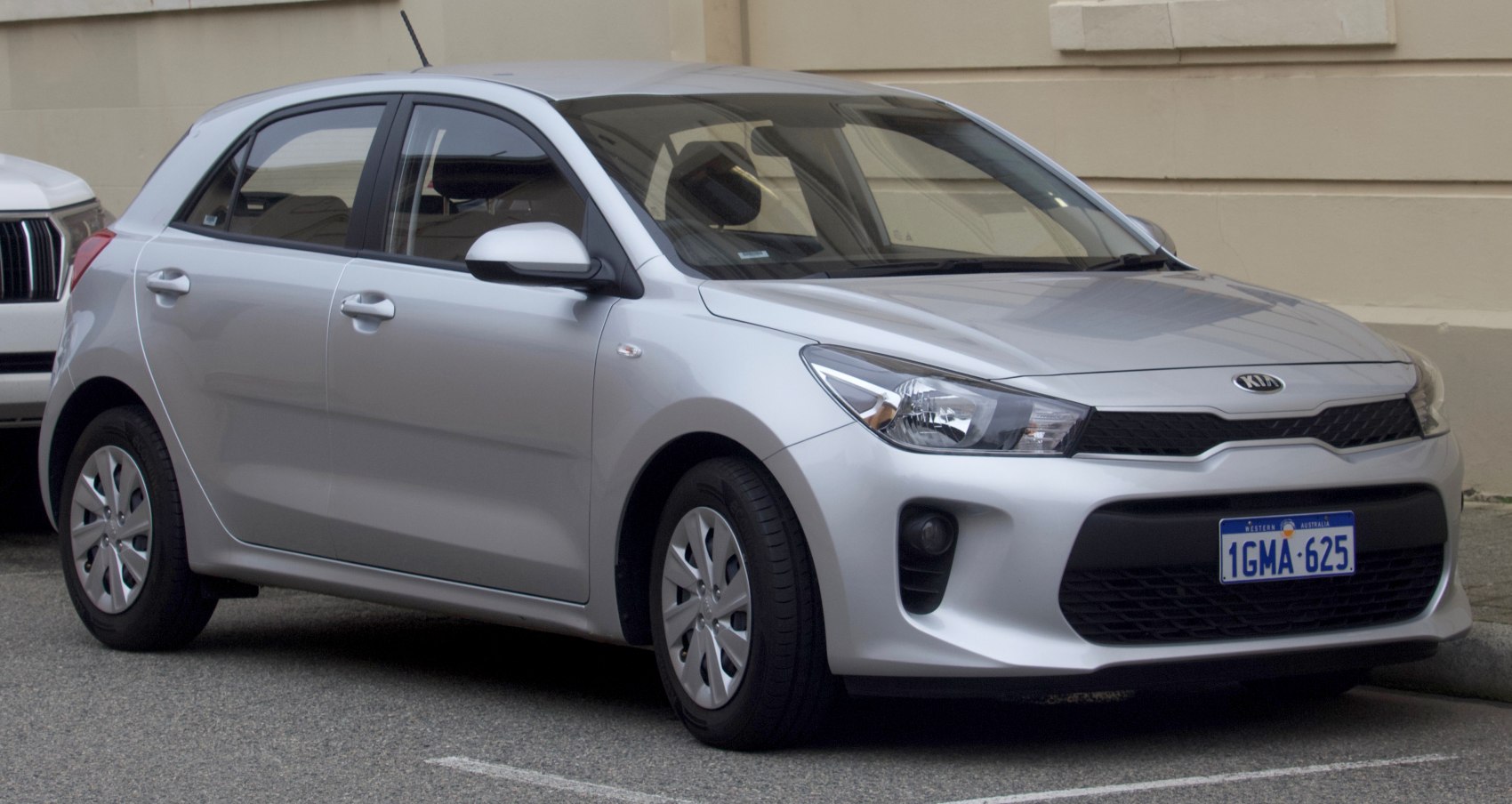 Silver compact hatchback with distinct front grille and headlights