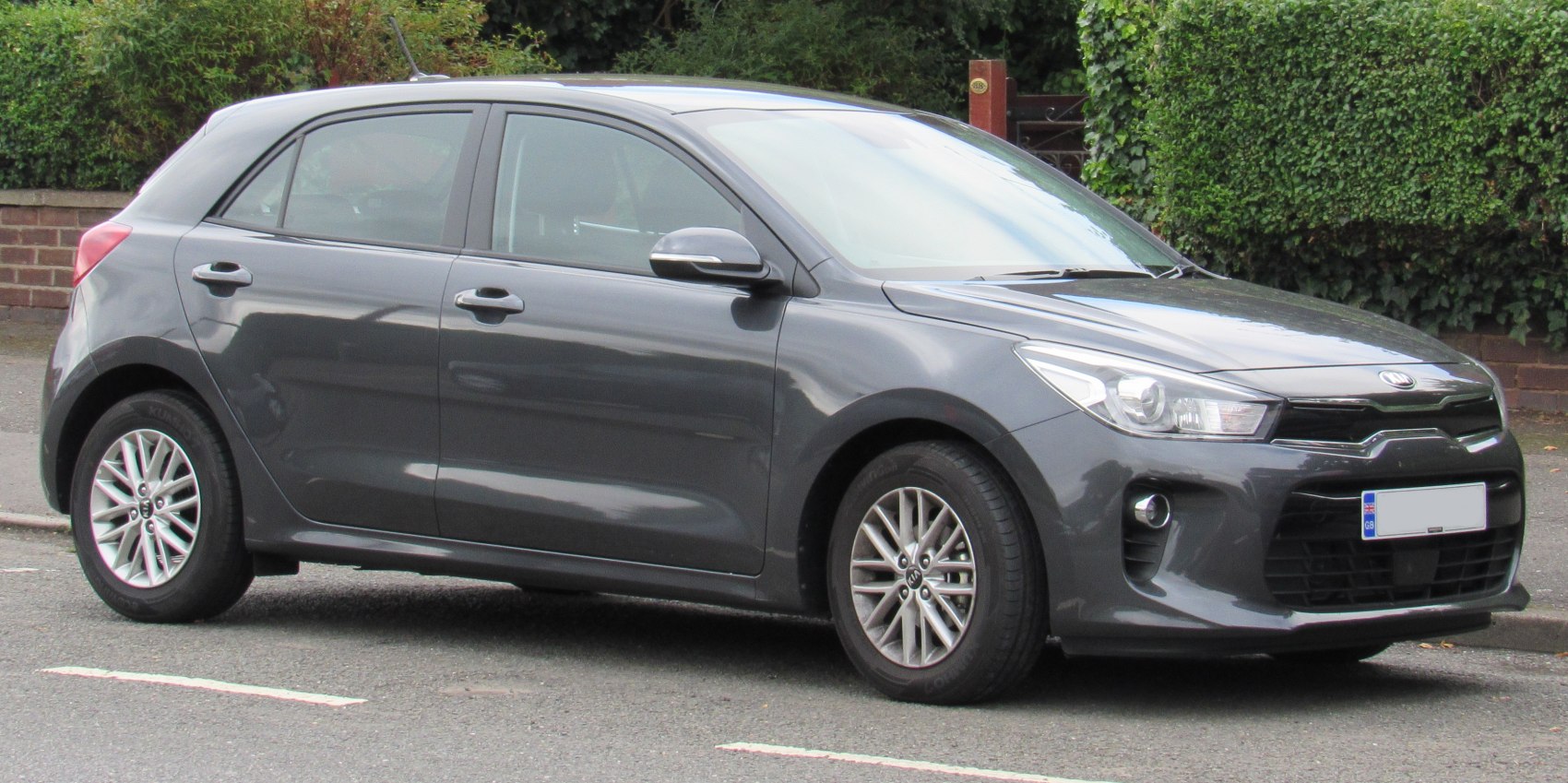 Grey hatchback front side profile with alloy wheels and grille