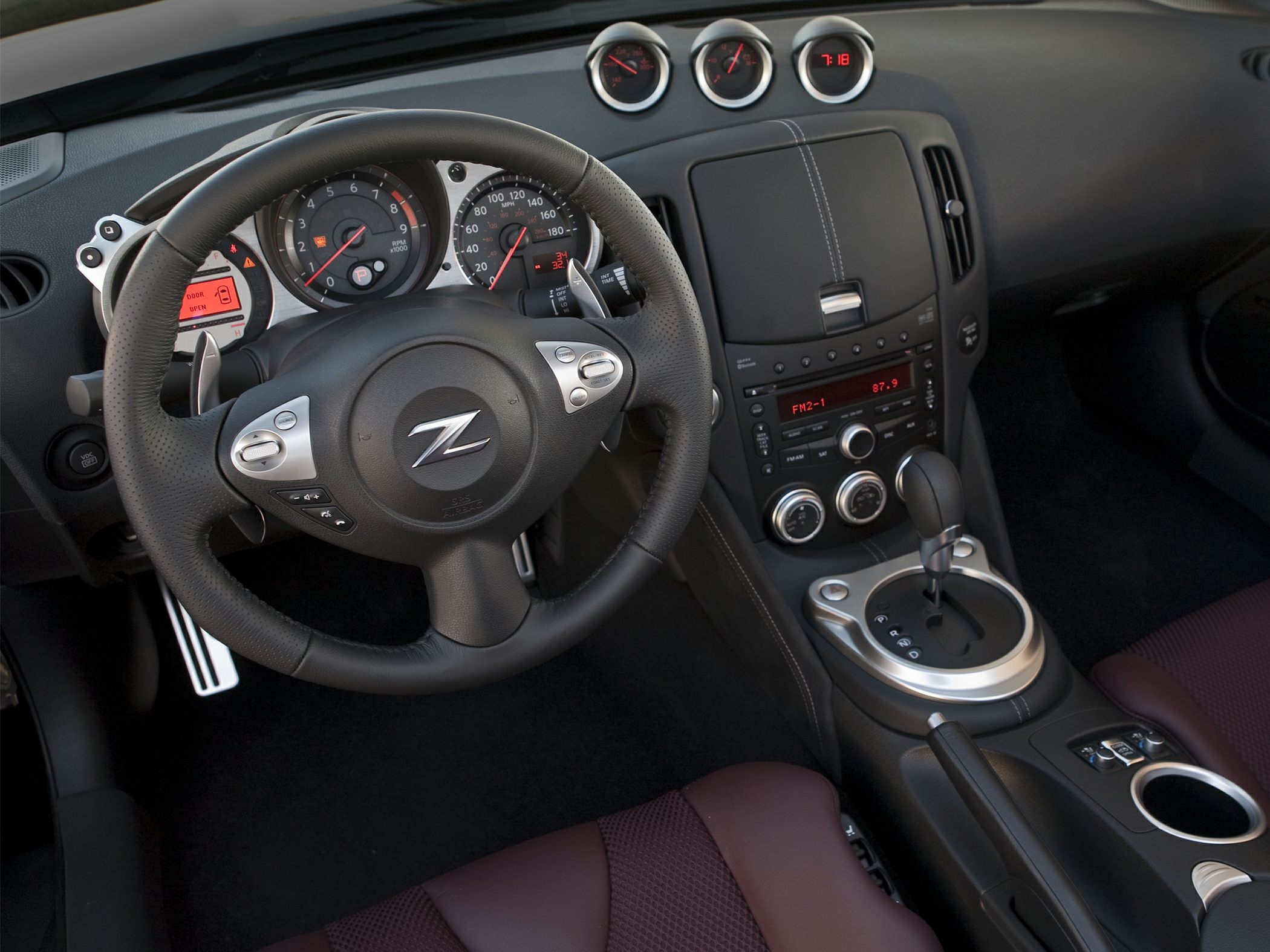 Steering wheel with 'Z' emblem and dashboard gauges plus center console.