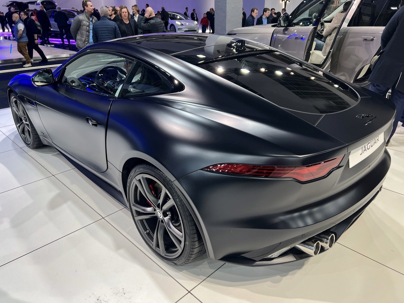 Rear and side view of a sleek sports coupe with dual exhausts