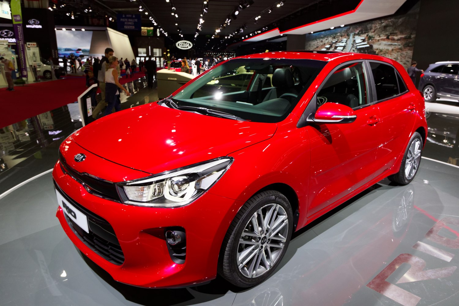 Red hatchback with modern headlights and alloy wheels