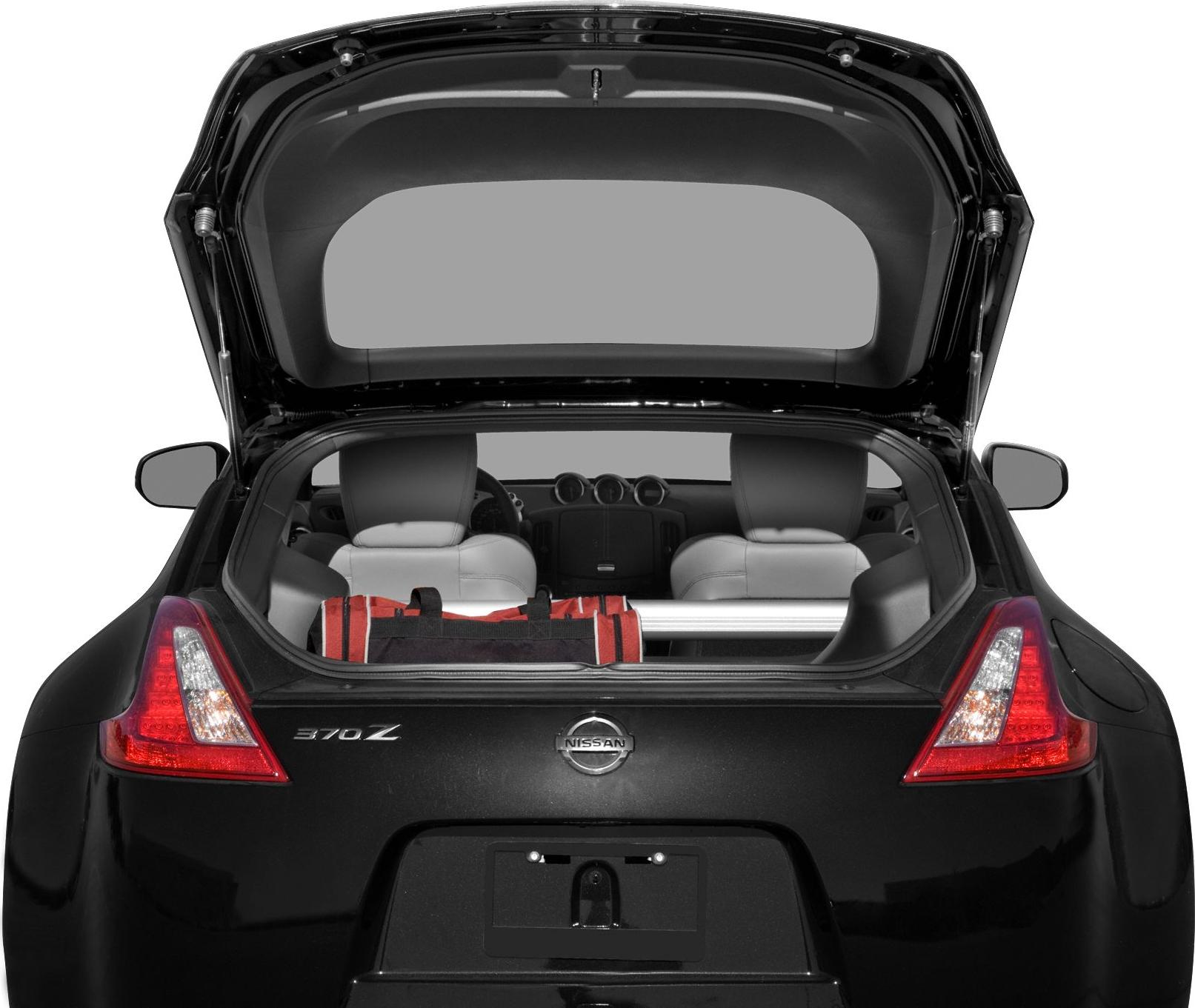 Rear view with open trunk revealing sports car interior and taillights.