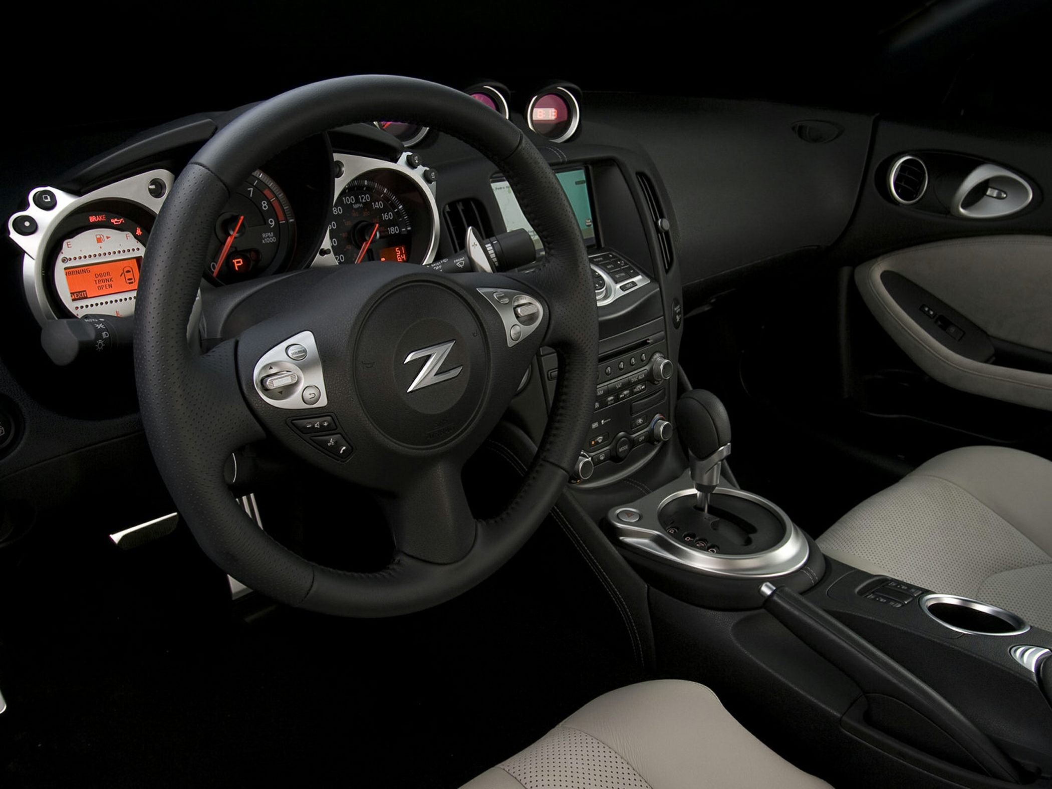 Sporty steering wheel and dashboard with gauges and center console