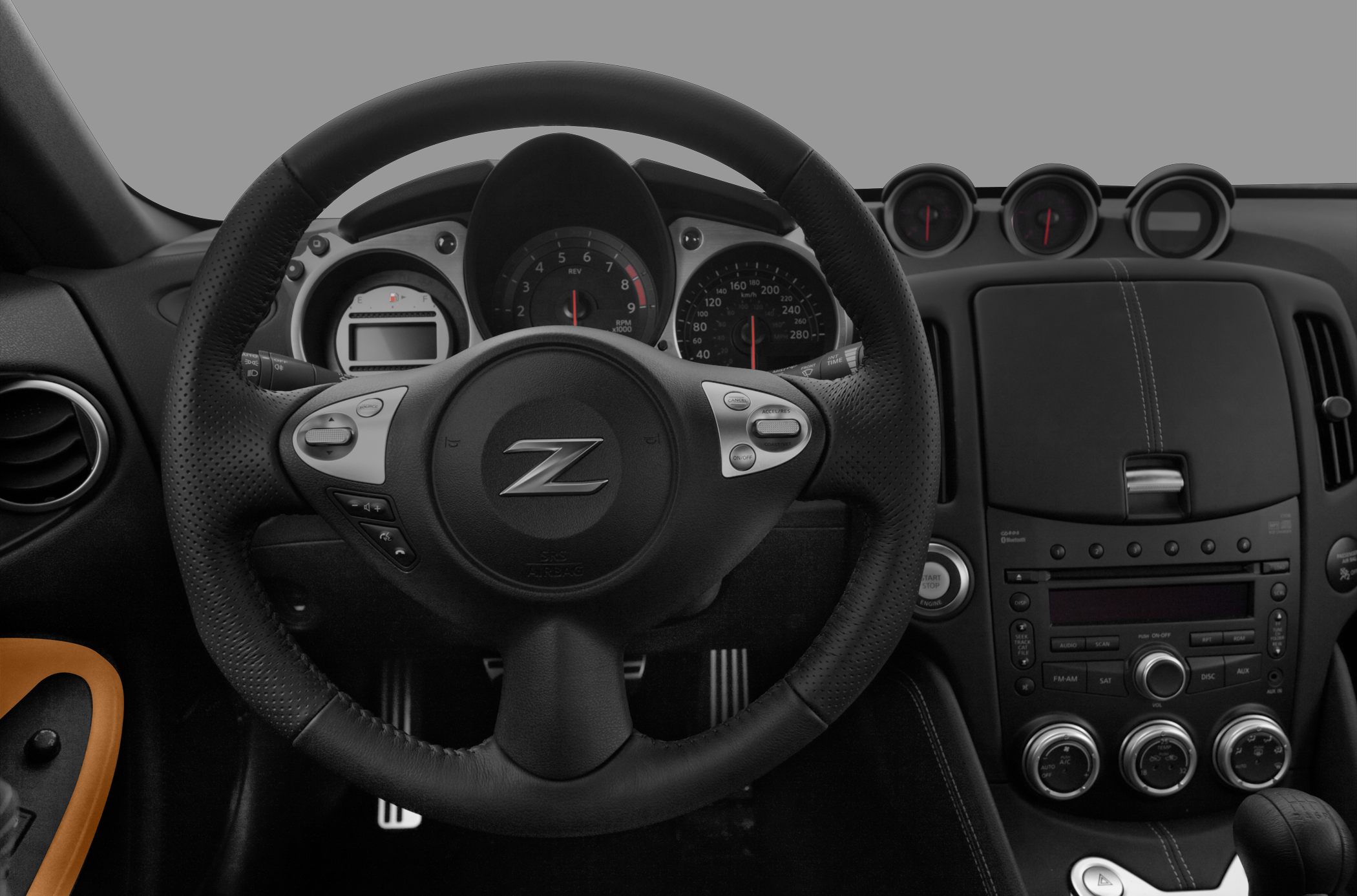 Steering wheel with center Z logo and instrument cluster gauges