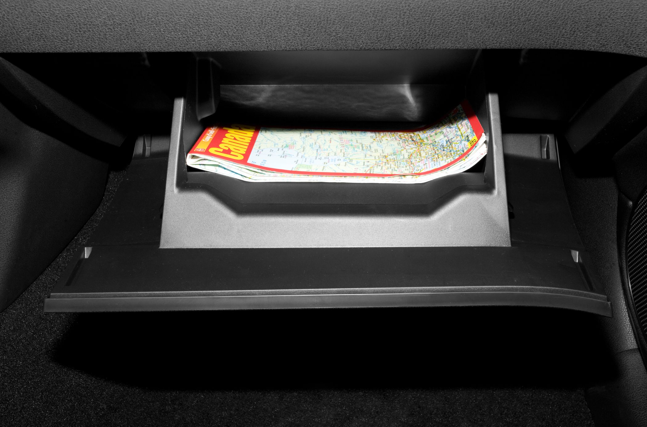 Open glove compartment with map storage and molded plastic design