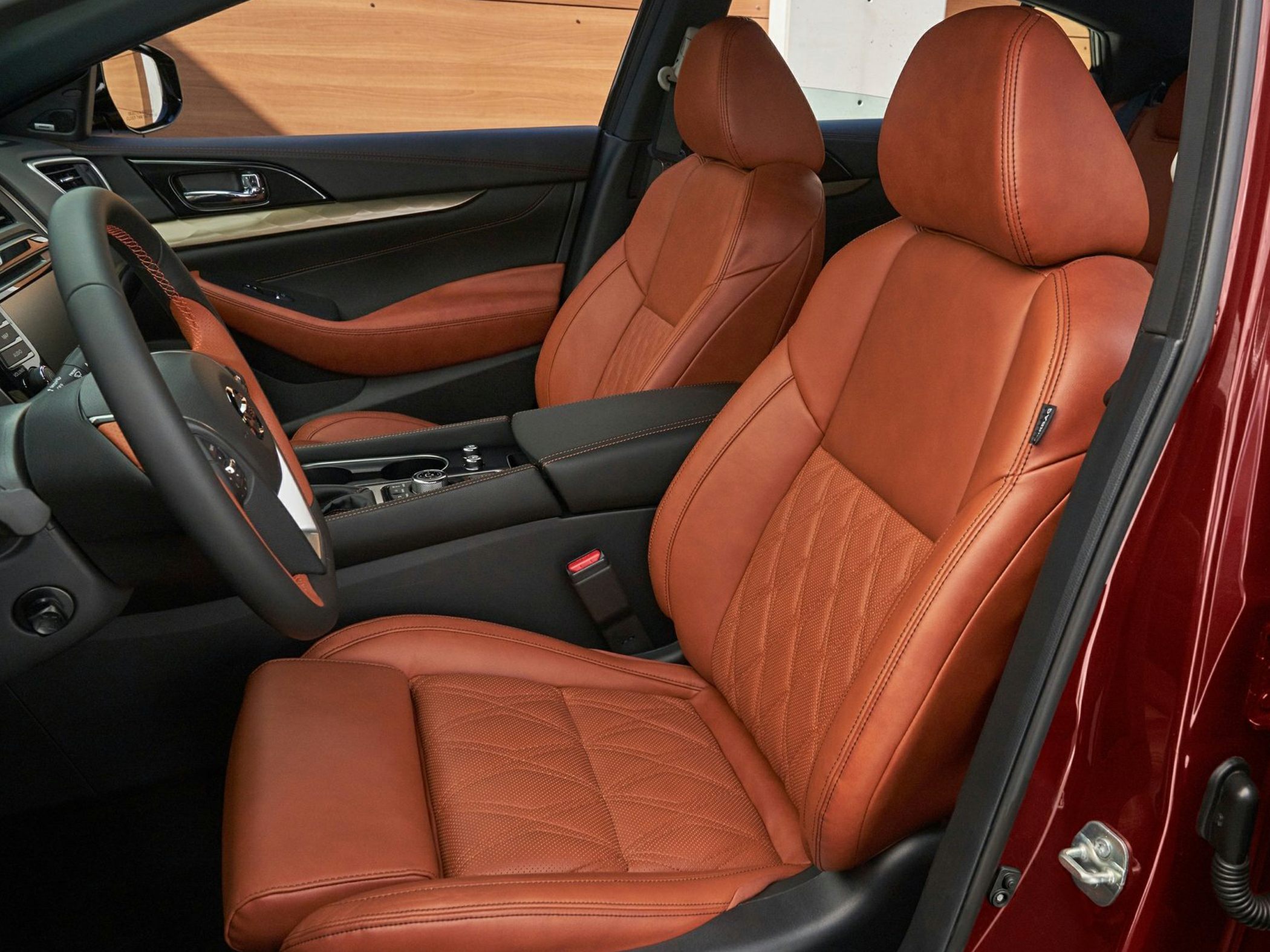Luxury brown leather seats with detailed stitching and modern dashboard.