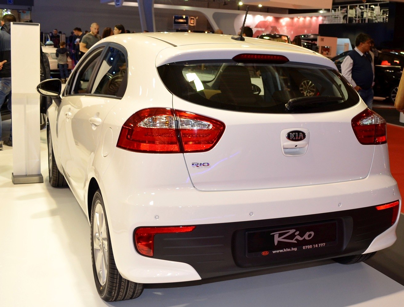 Compact hatchback rear with distinct tail lights and parking sensors.