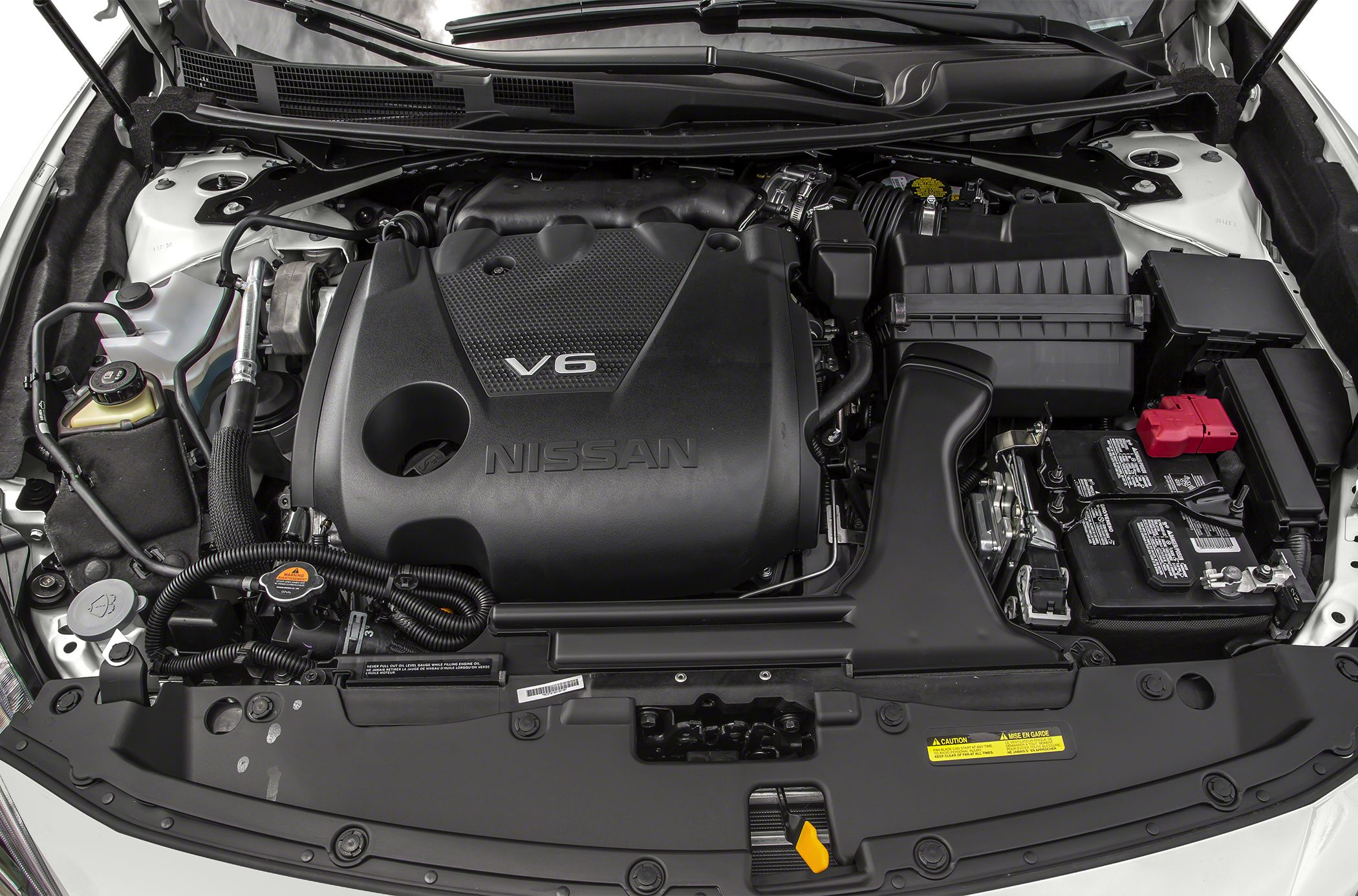 Detailed view of a V6 engine bay with visible components and battery