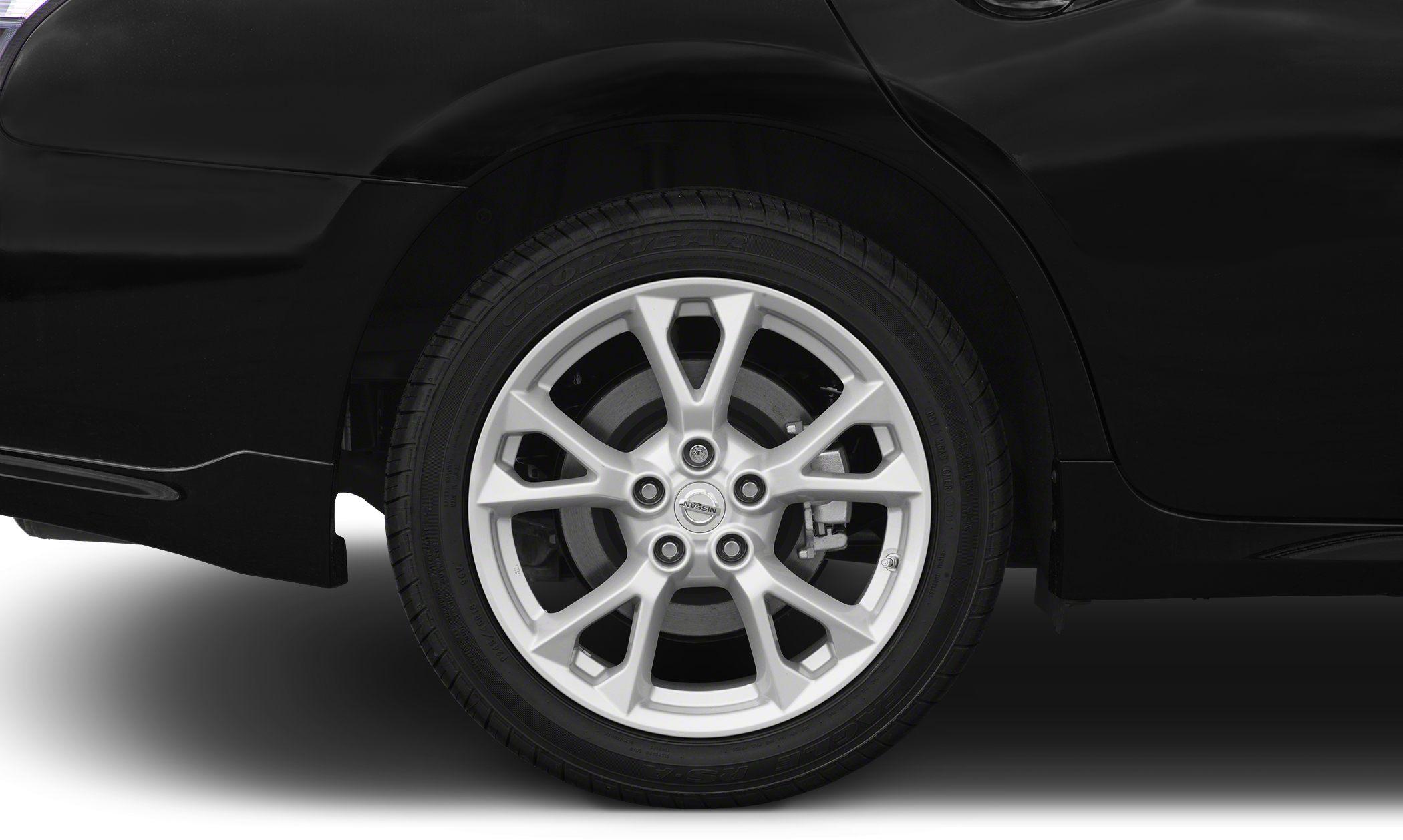 Silver alloy wheel and tire close-up with Nissan logo