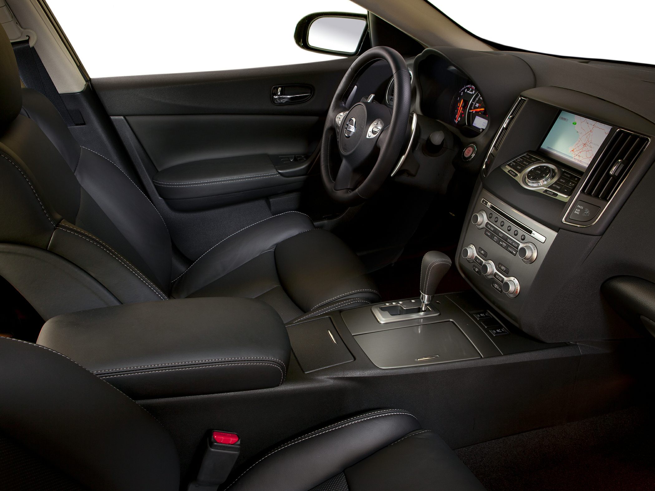 Interior with dashboard, steering wheel, center console, and navigation screen