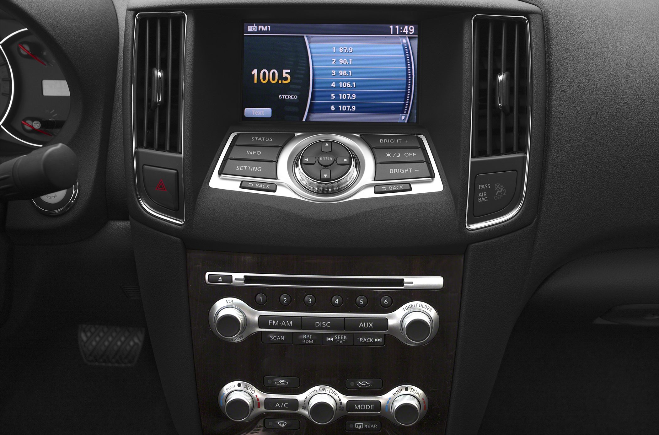 Car infotainment screen and climate control panel with buttons and knobs